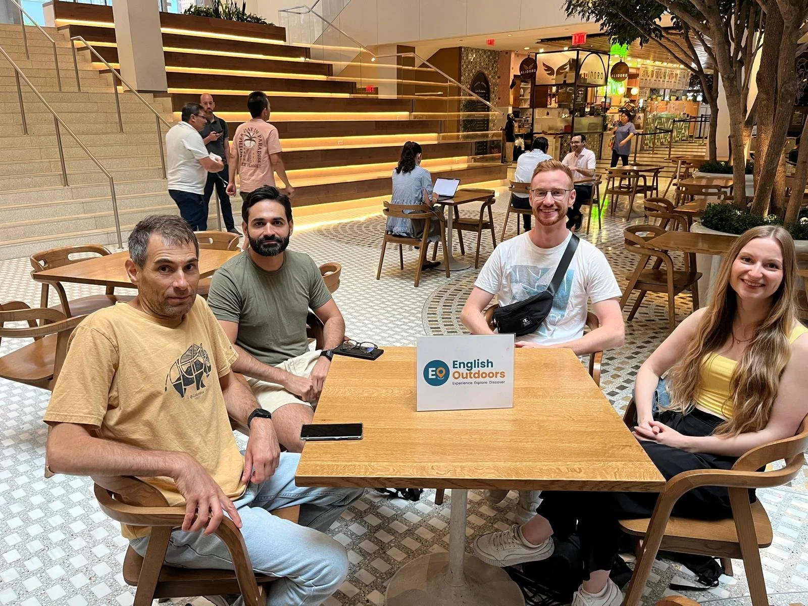 Group of students sitting at a table indoors at the class location, The Hugh