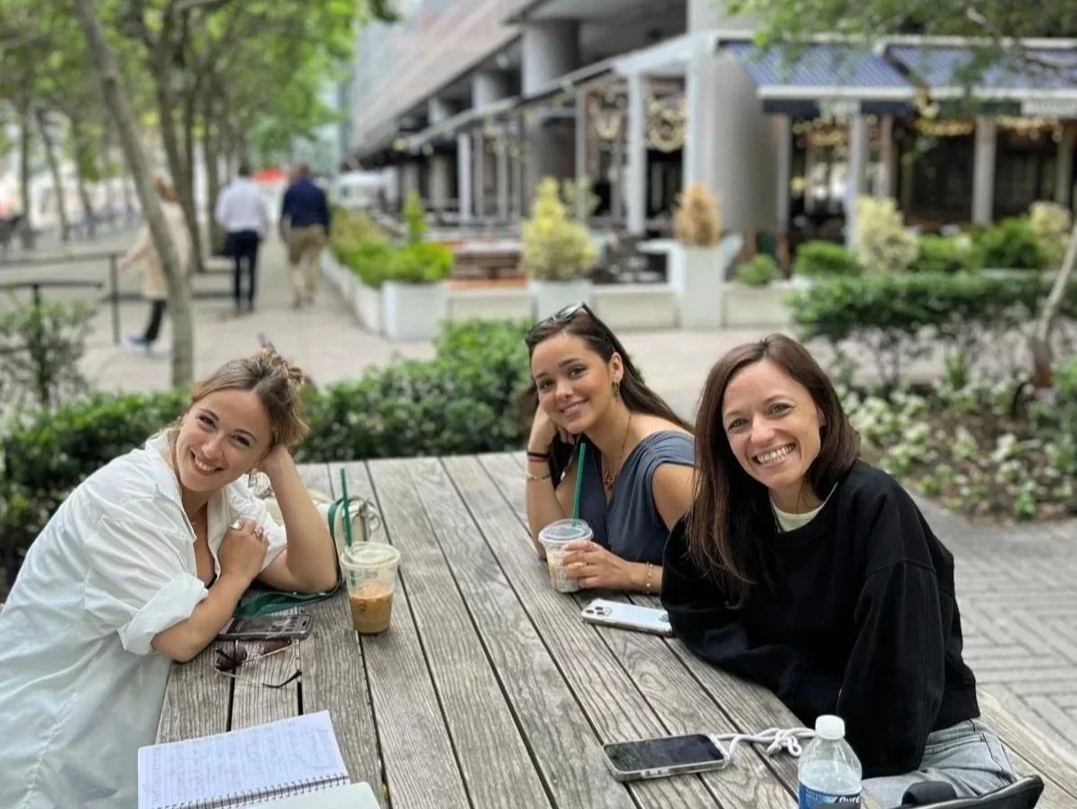 Group of three women sitting at an outdoor table at Brookfield Place
