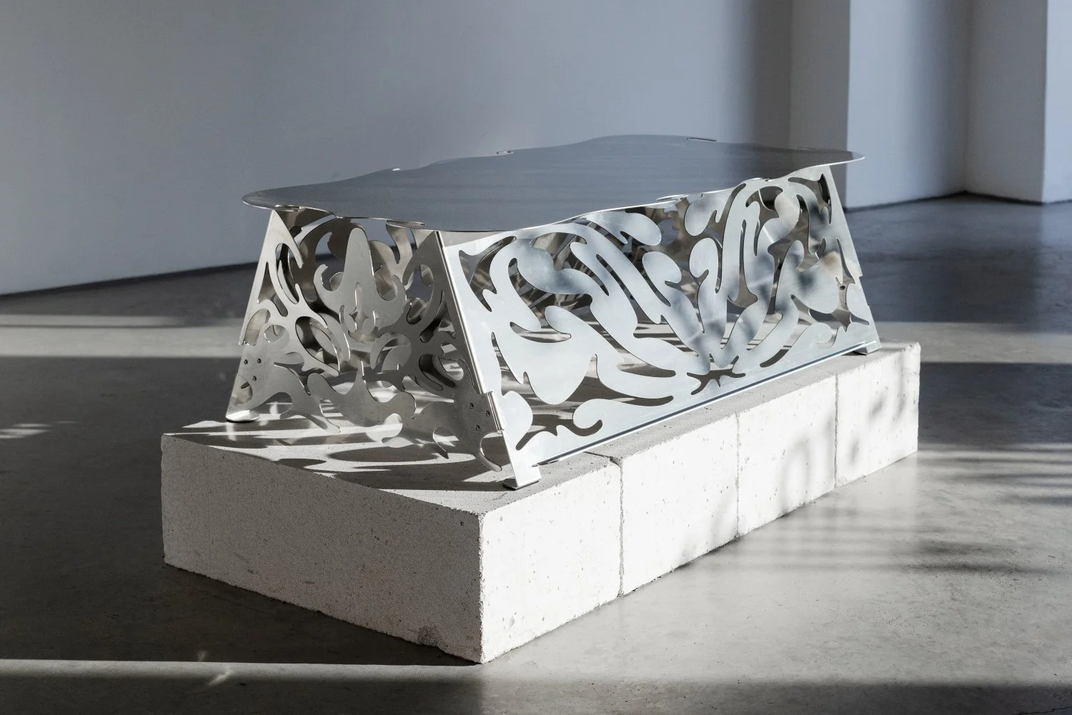 Aleksandrs Breže, Coffee table from series Threshold, 2026, Mirror-polished stainless steel  34 x 57 x 102  cm. Photo: Kristīne Madjare