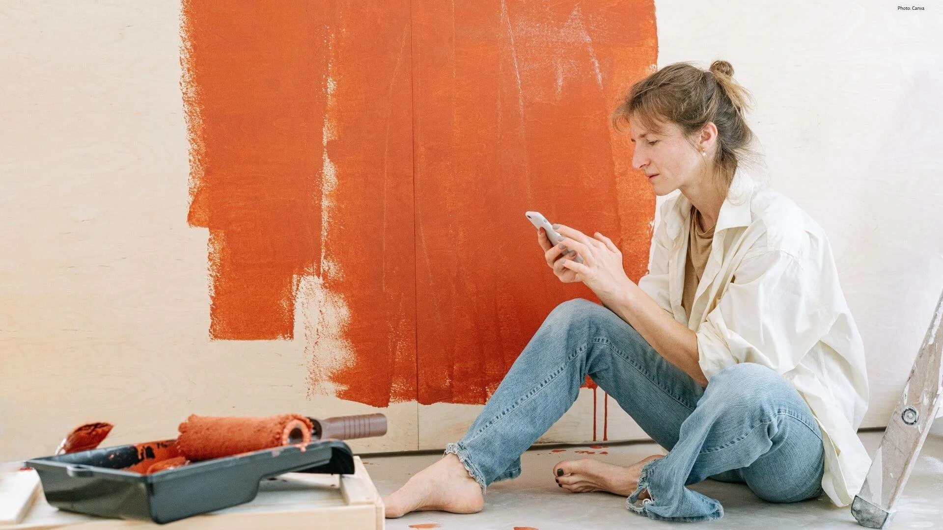 woman painting walls orange