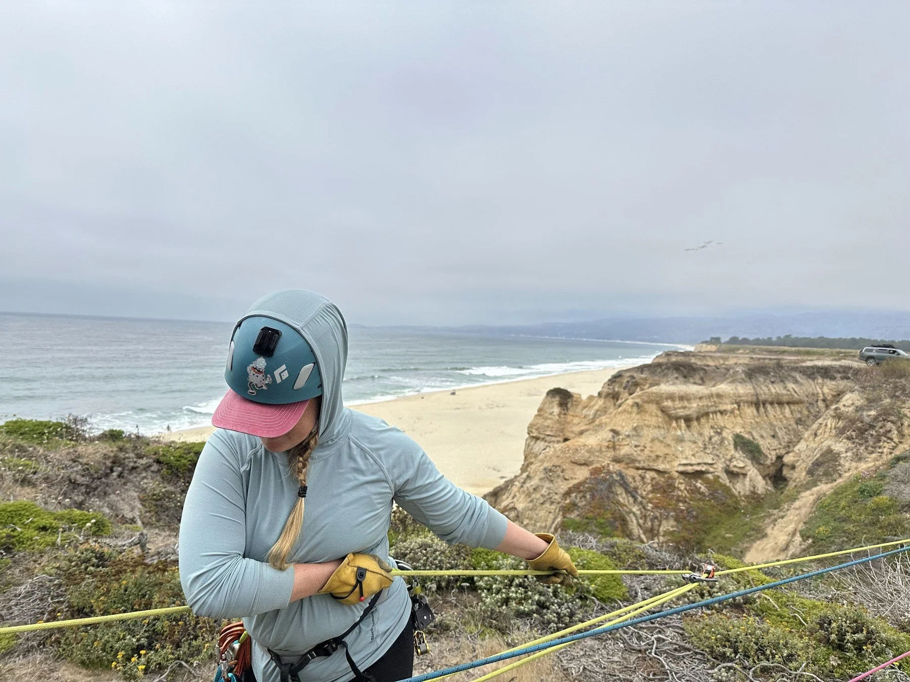 Volunteer practicing rope handling during a coastal rigging workshop.