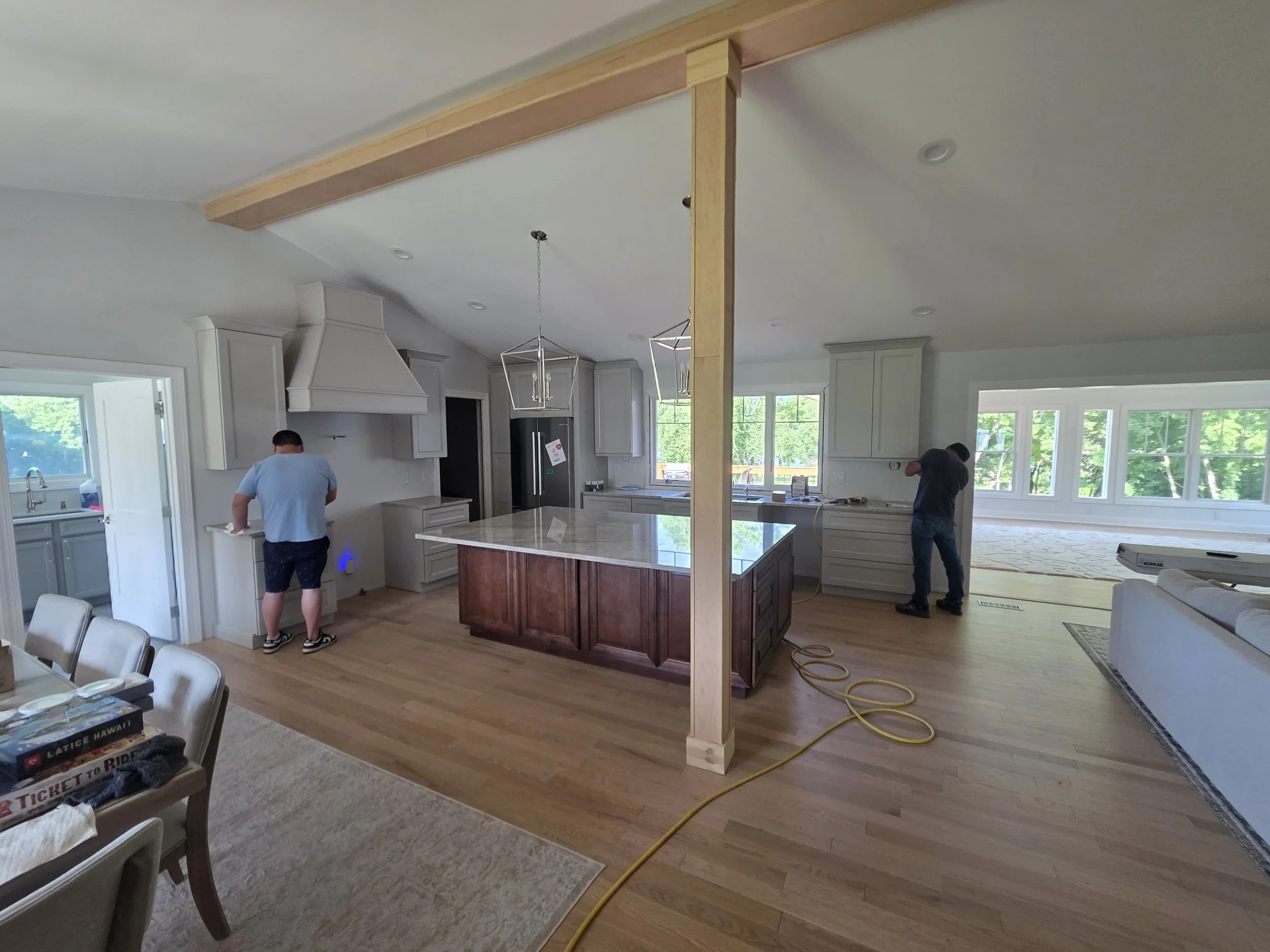 Dove White Perimeter Cabinets/ Chocolate Glazed Island/ Taj Mahal Countertops