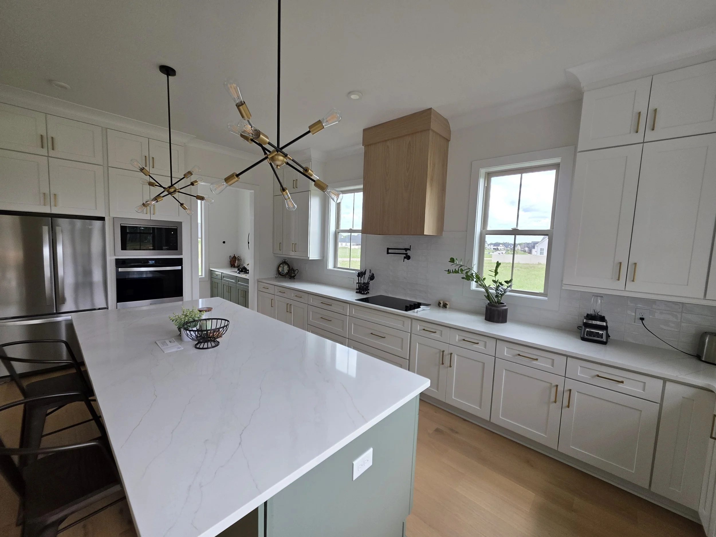 White Shaker Perimeter Cabinets/ Sage Green Island/ Colorado Quartz