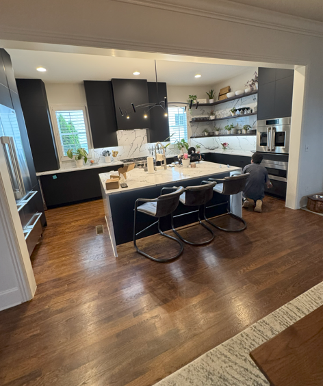 Black European Cabinets/ Calcatta Panda Quartz/ Waterfall Edge