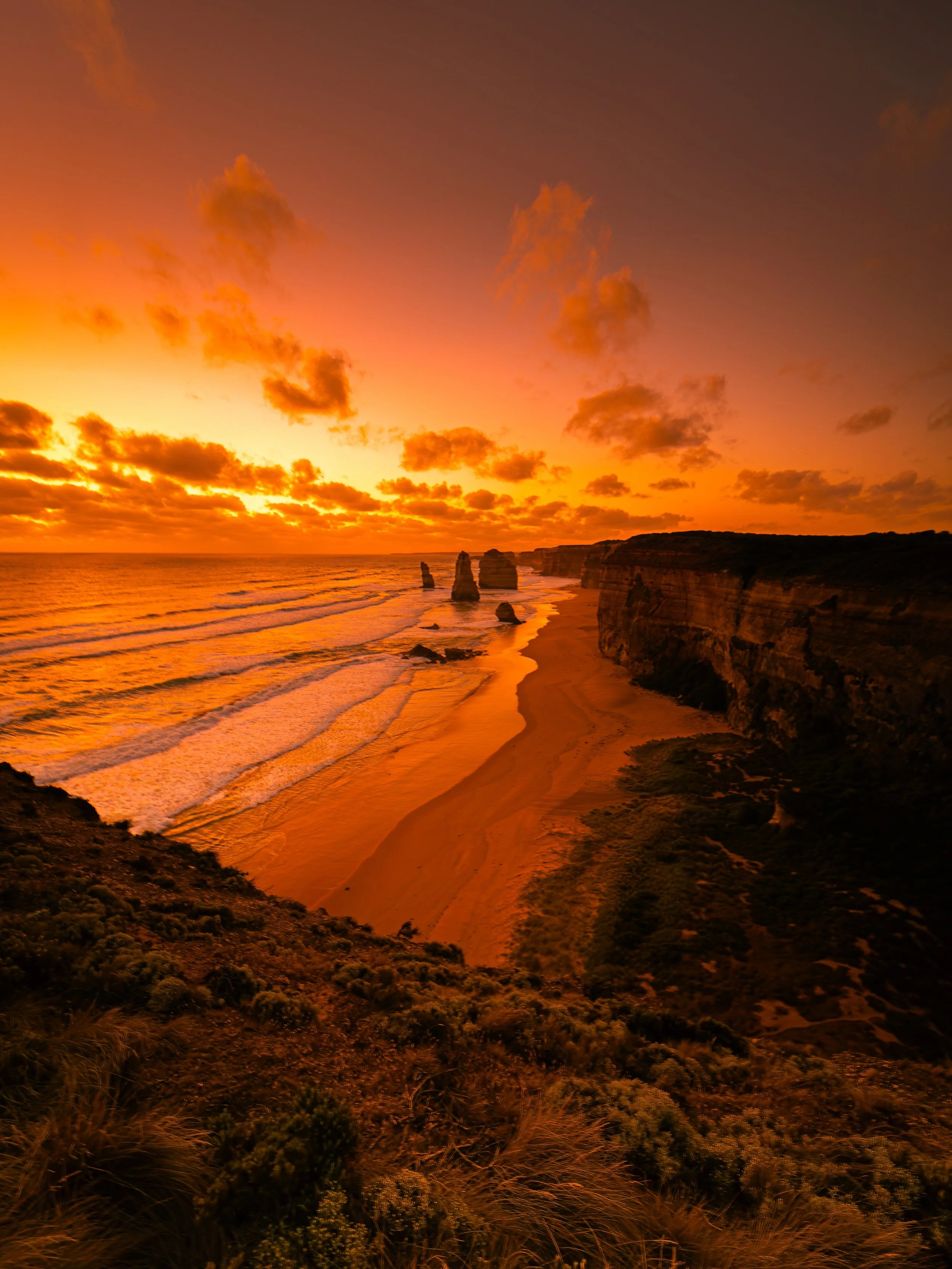 Would you stop here for a moment? 🌅

Standing above the Twelve Apostles, watching the sky slowly burn orange while the waves rolled endlessly below, everything went quiet for a moment. No rush, no noise &mdash; just the ocean, the wind, and that fee