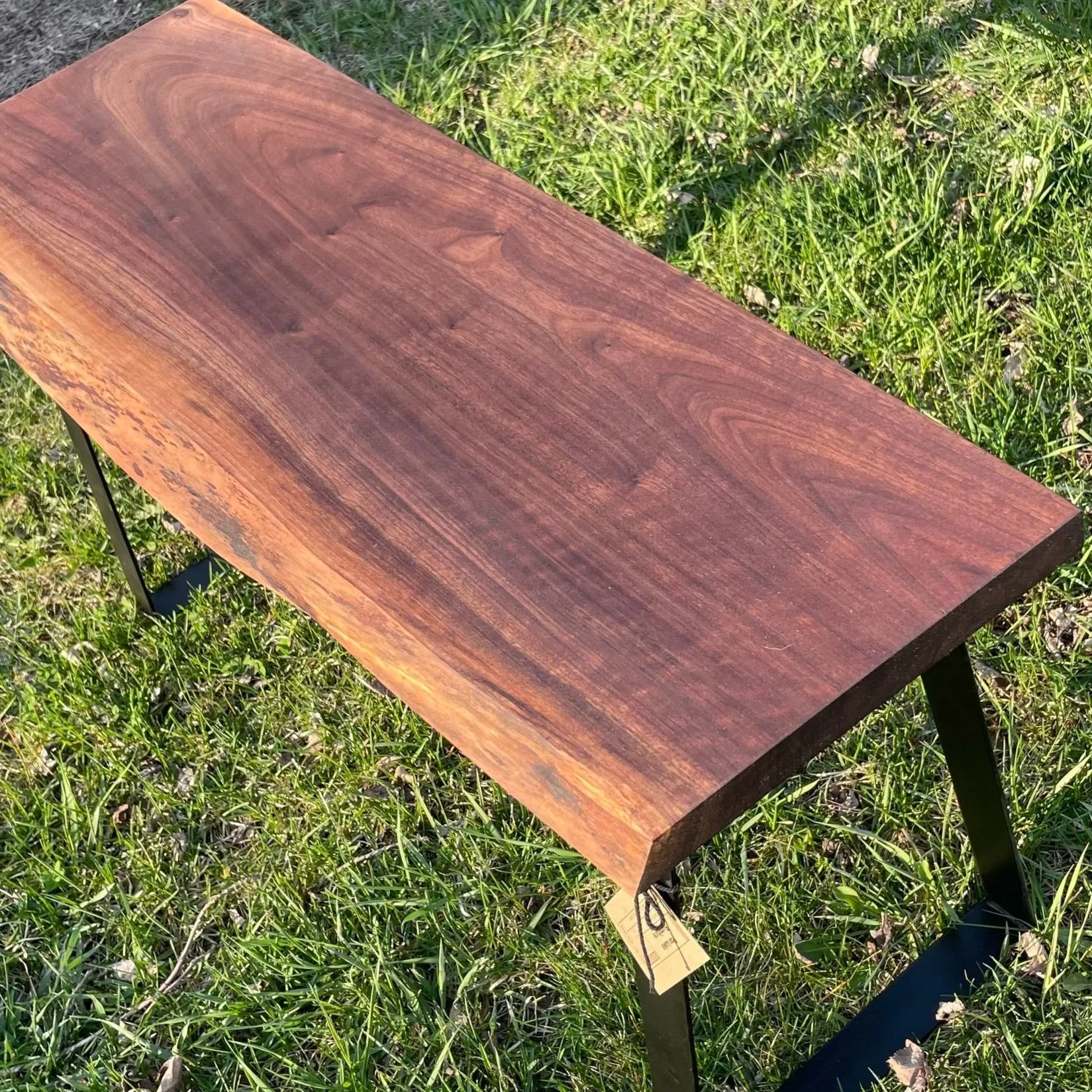 walnut table with metal legs outside