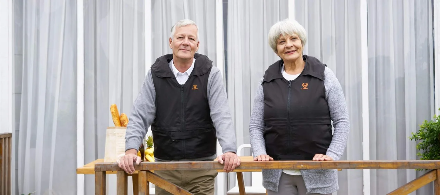 Two older adults wearing black S-Airbag Pro safety vests