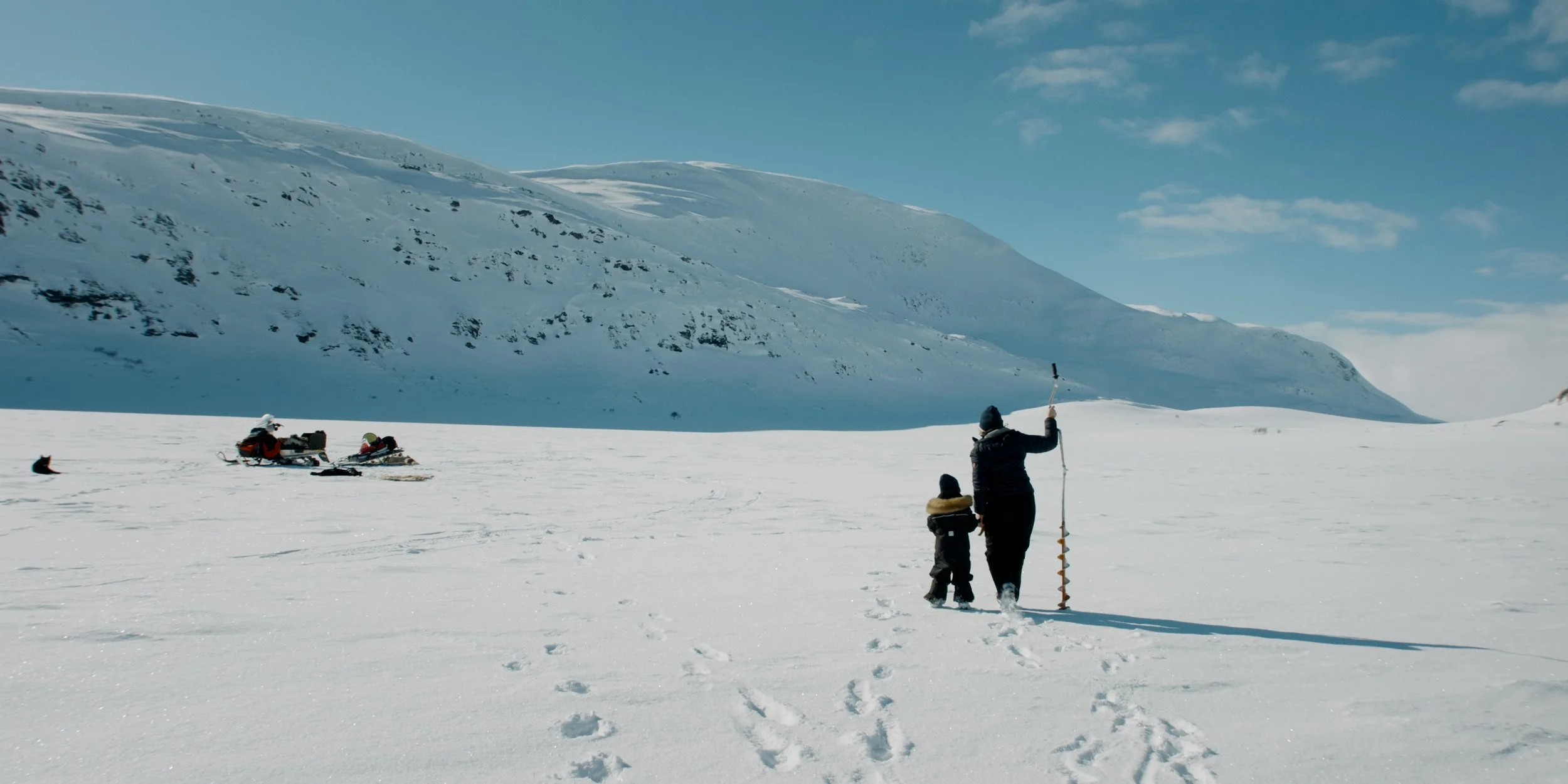 For Our Rights Still image of woman and child walking in a snowy landscape