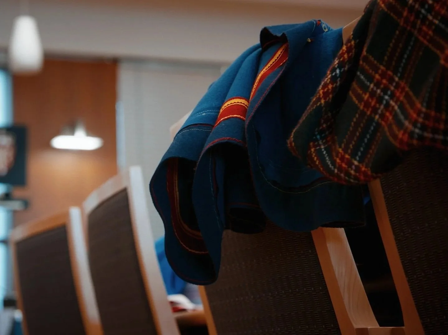 For Our Rights still image of gákti hanging over chair in court room