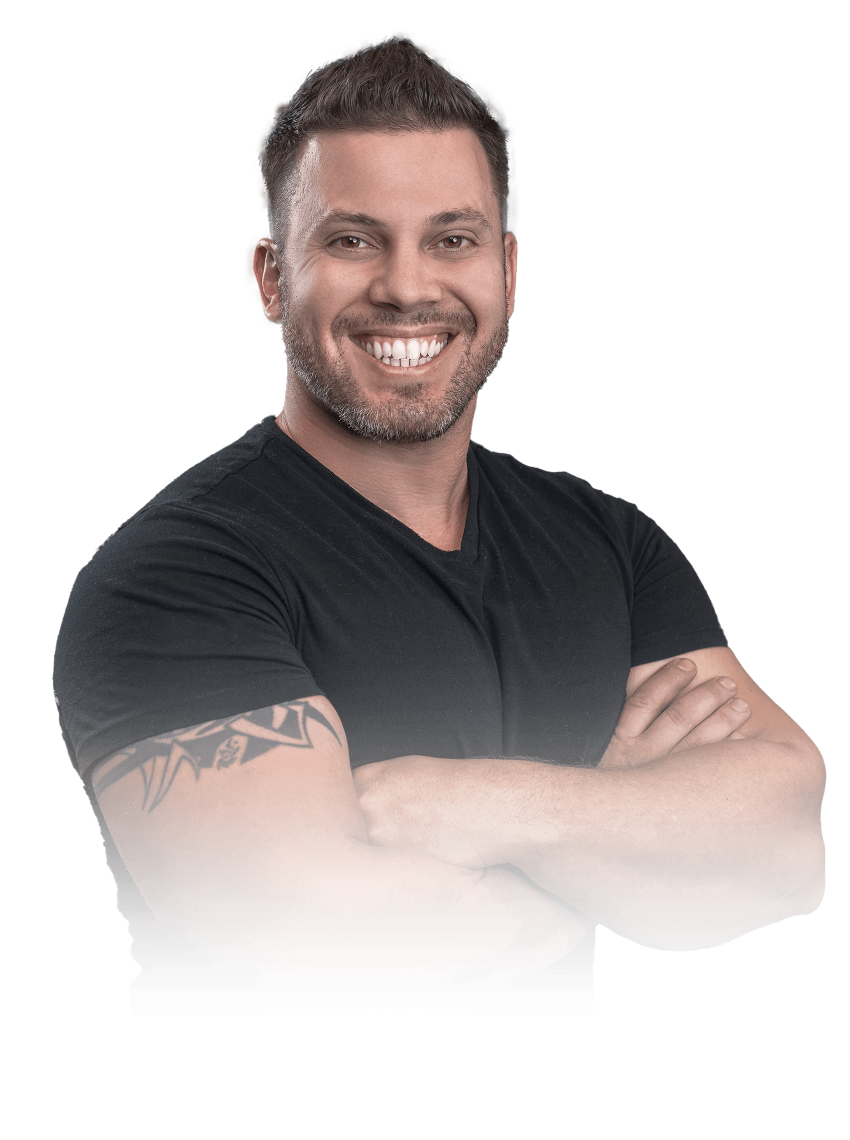 Omar Colom Smiling man with short dark hair, beard, crossed arms, wearing a black t-shirt, and showing a tattoo on his left arm.