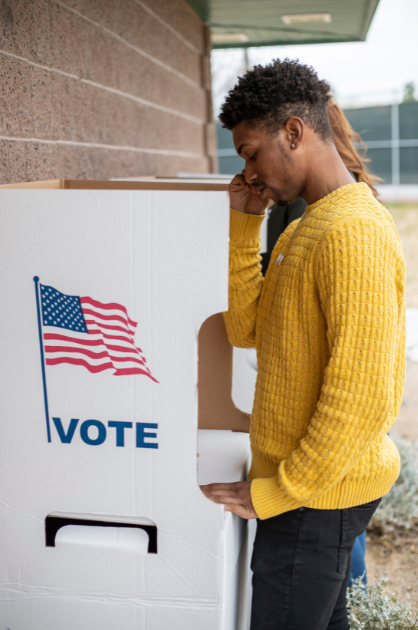 Man in yellow sweater voting