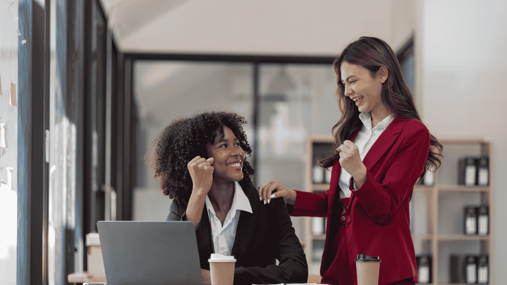 two women fist bumping at work