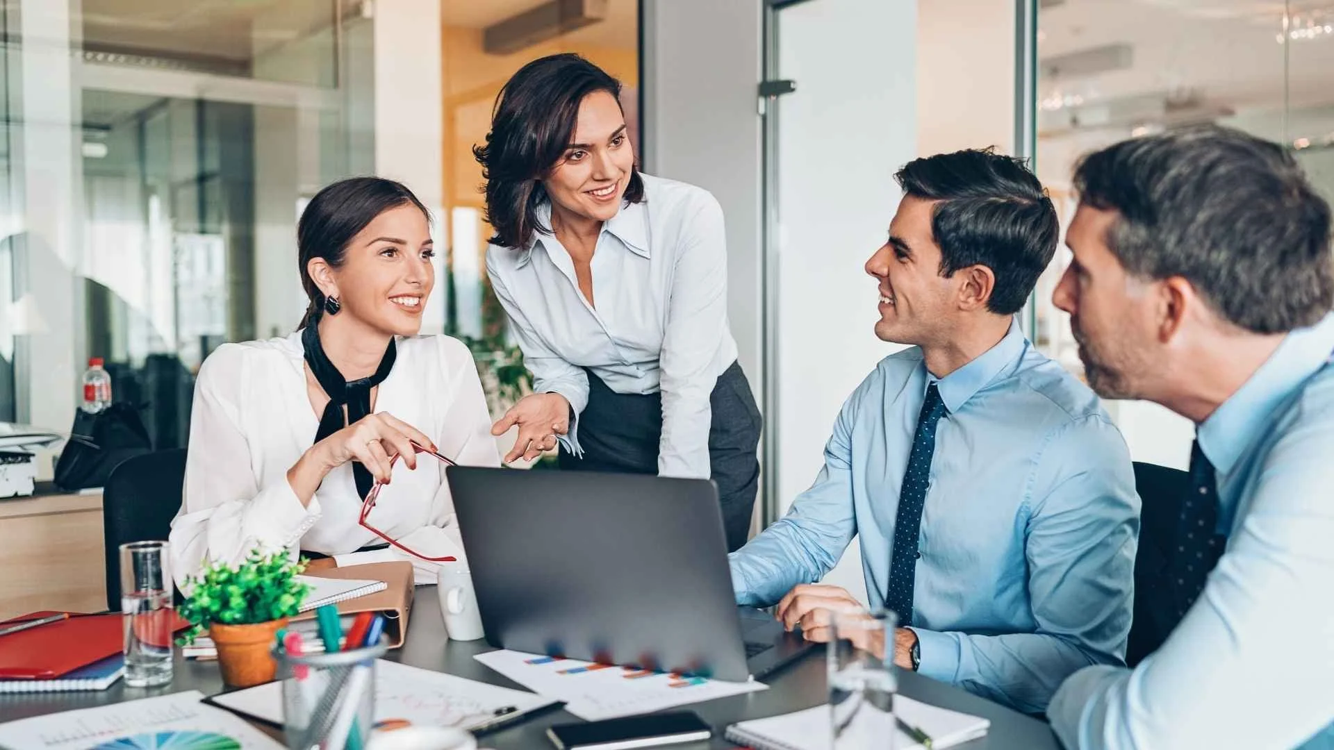 two men and two women in conference room
