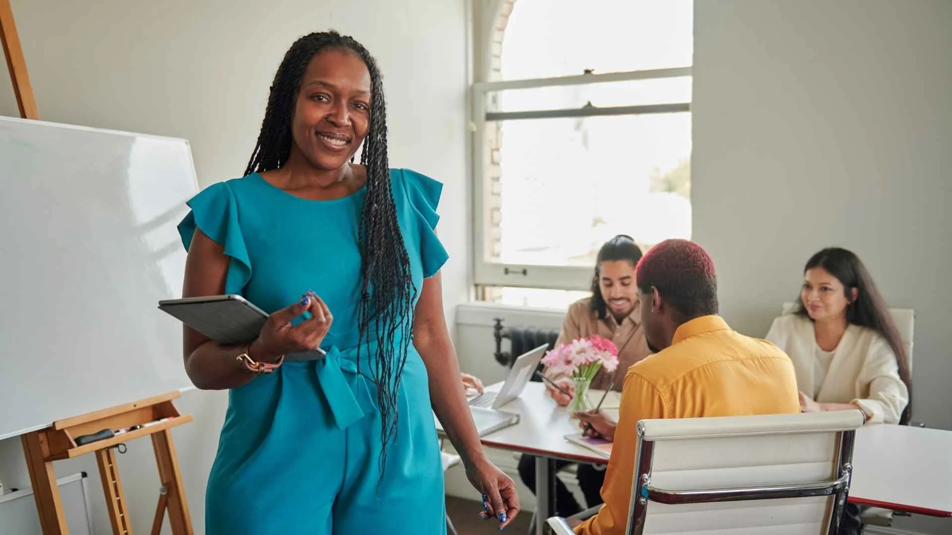 woman leader in turquoise with tablet