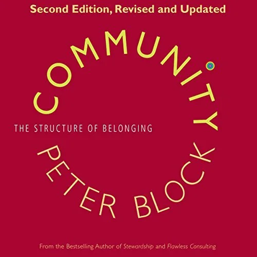 Cover of the book 'Community: The Structure of Belonging' by Peter Block, Second Edition, Revised and Updated. The title is in bold letters on a red background with text curving around.