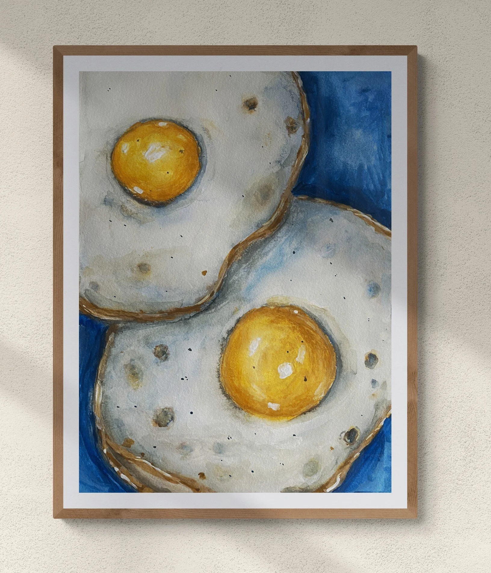 two sunny side up eggs on blue background framed hung on wall.jpg