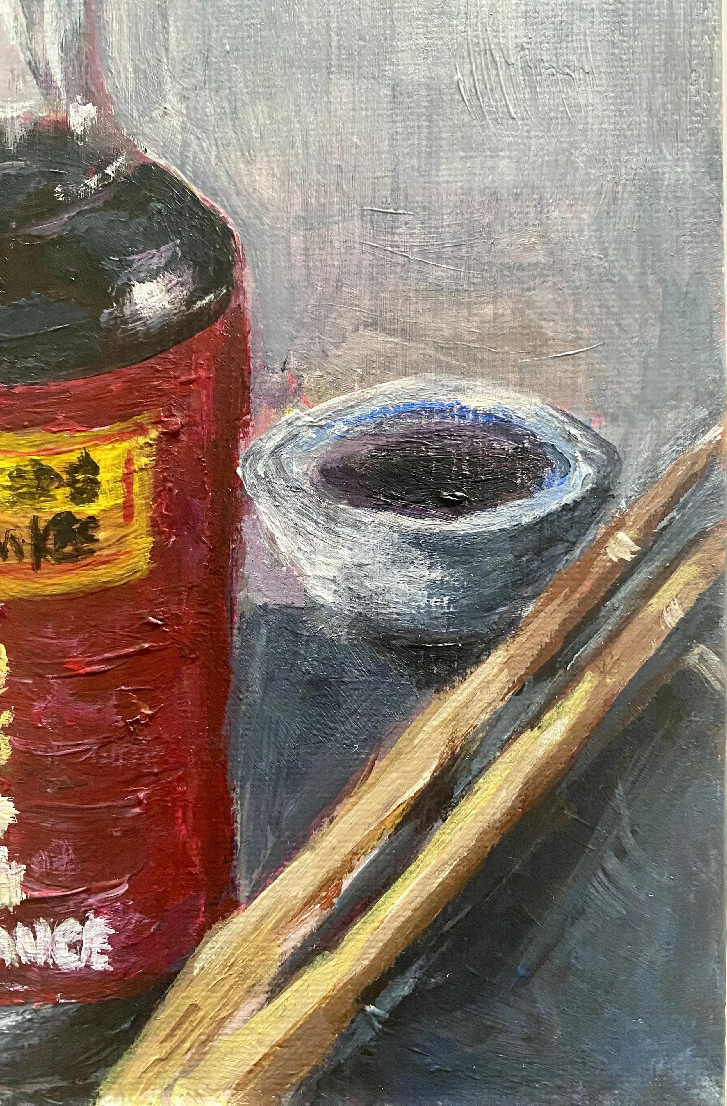 soy sauce bottle with small bowl and wooden chopsticks on grey background..jpg