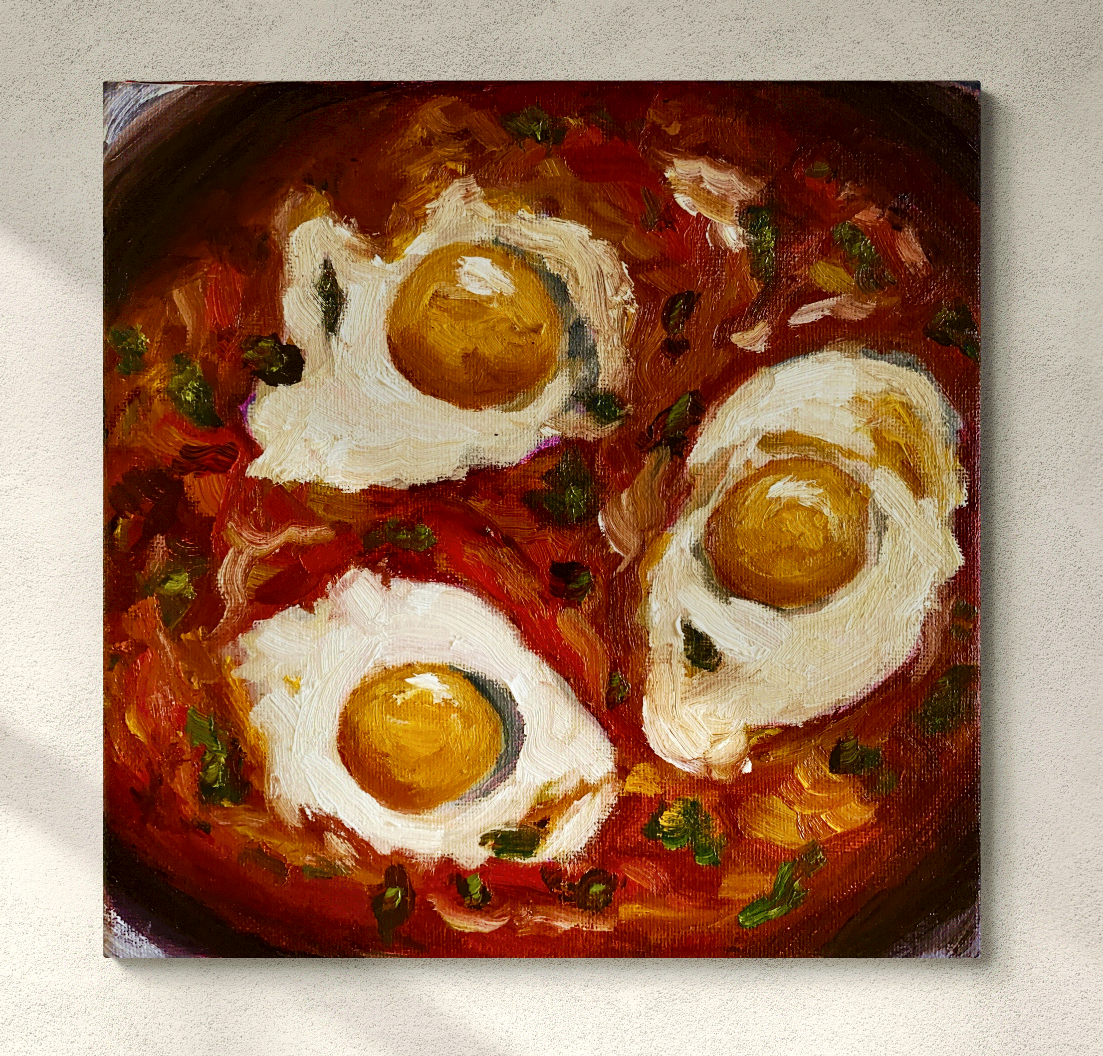 eggs and tomatoes shakshuka painting hung in room cropped.png