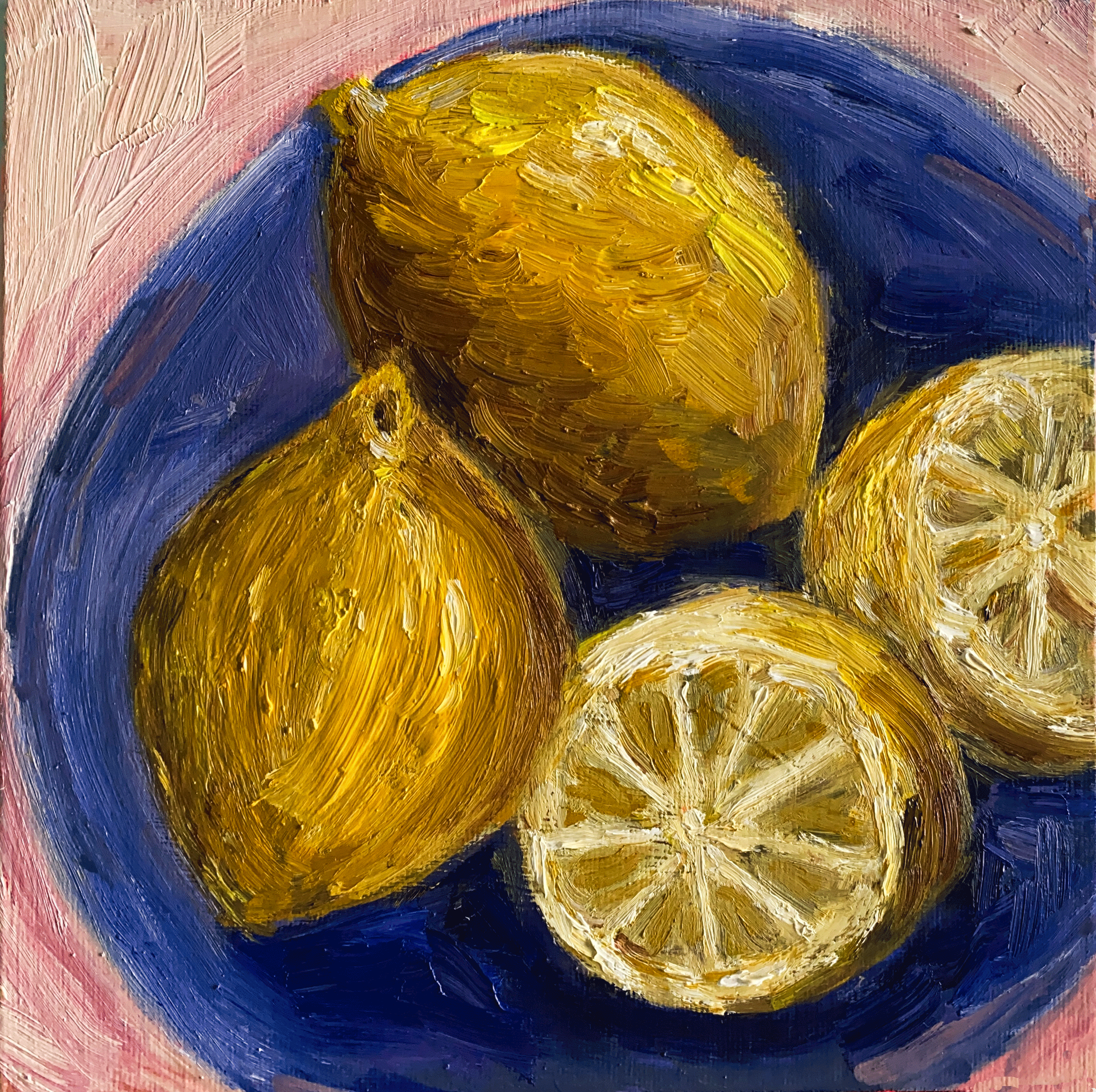 lemons and lemon slices on blue plate