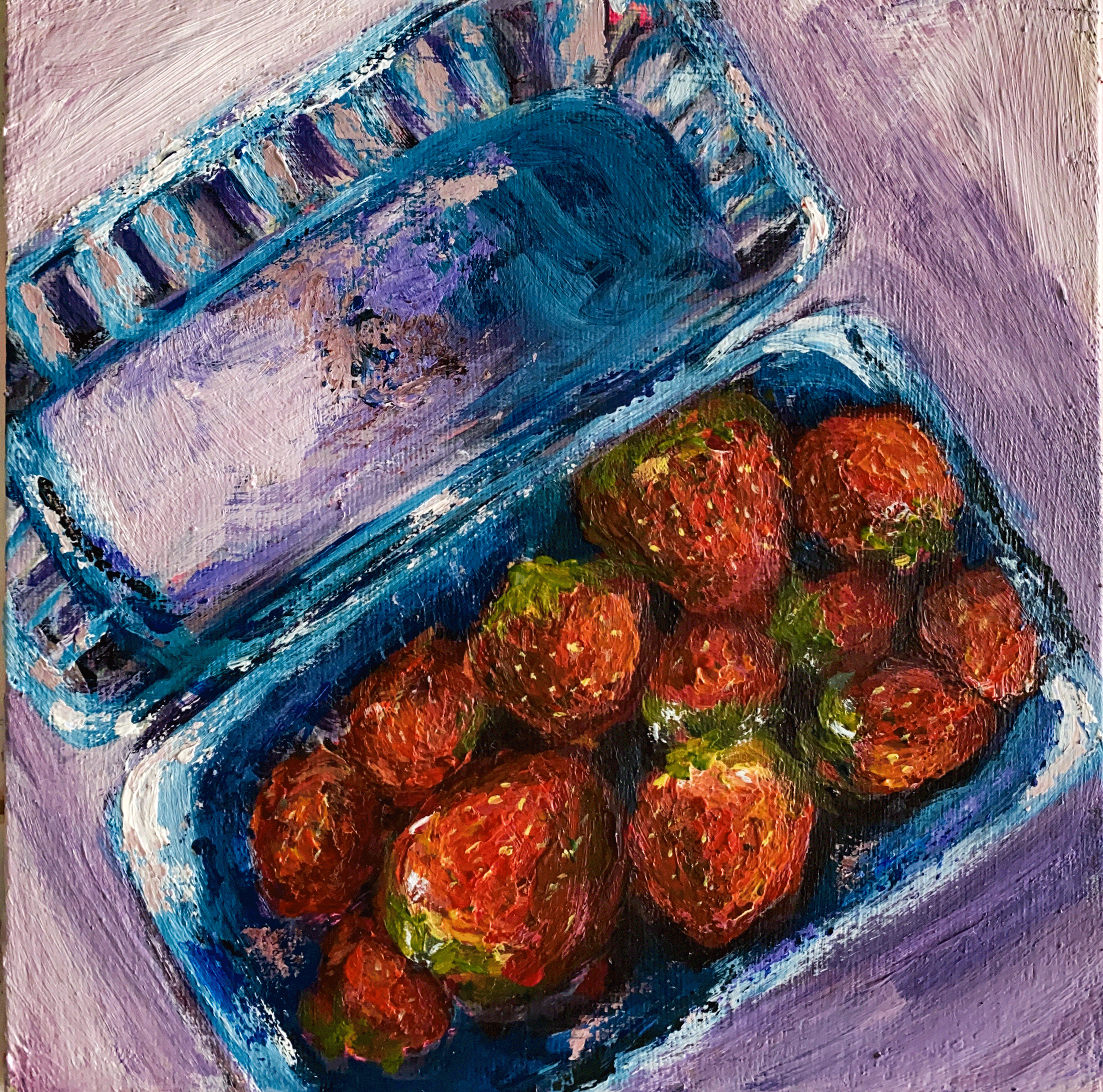 box of strawberries on lilac background