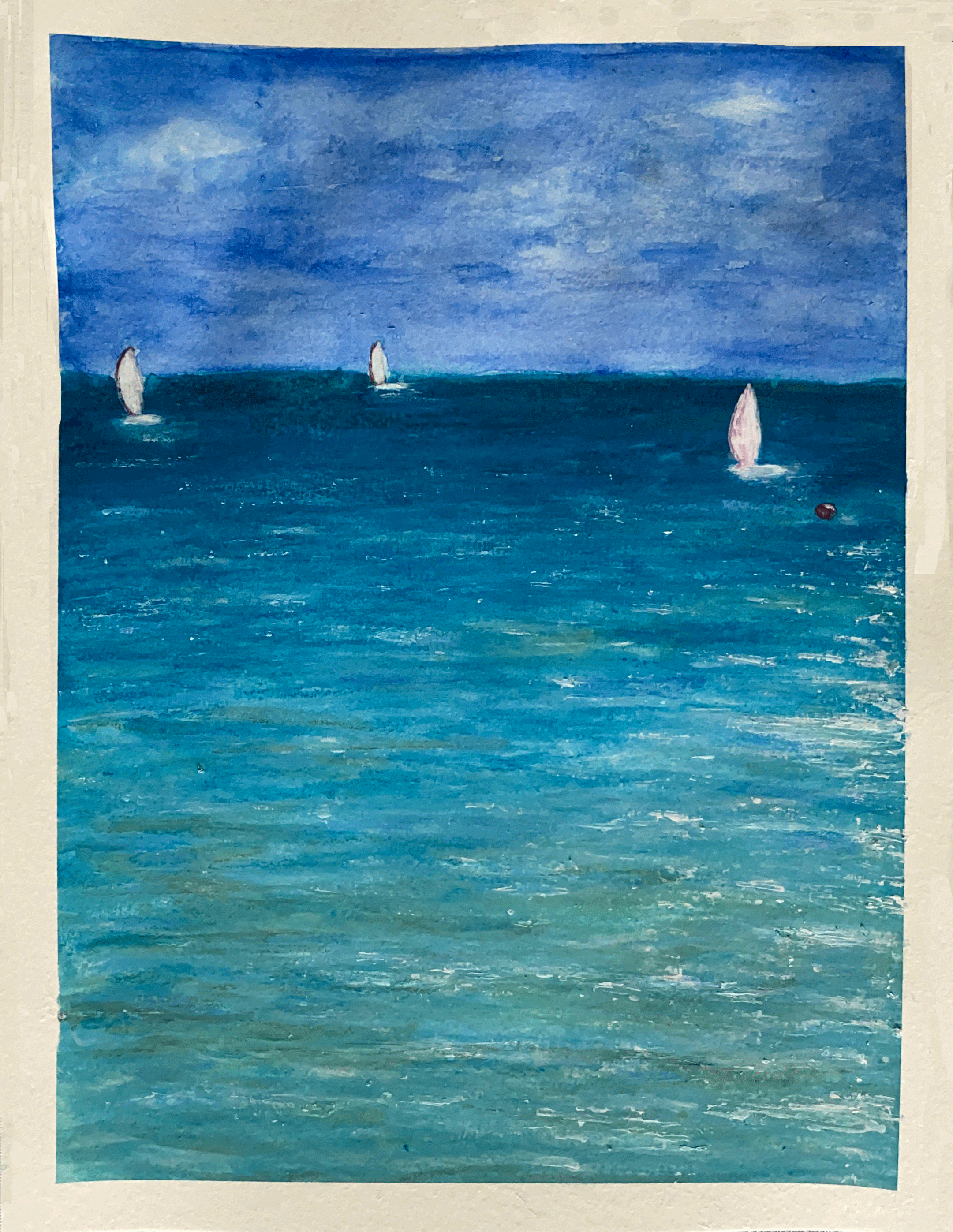blue ocean with sailboats in the distance.png