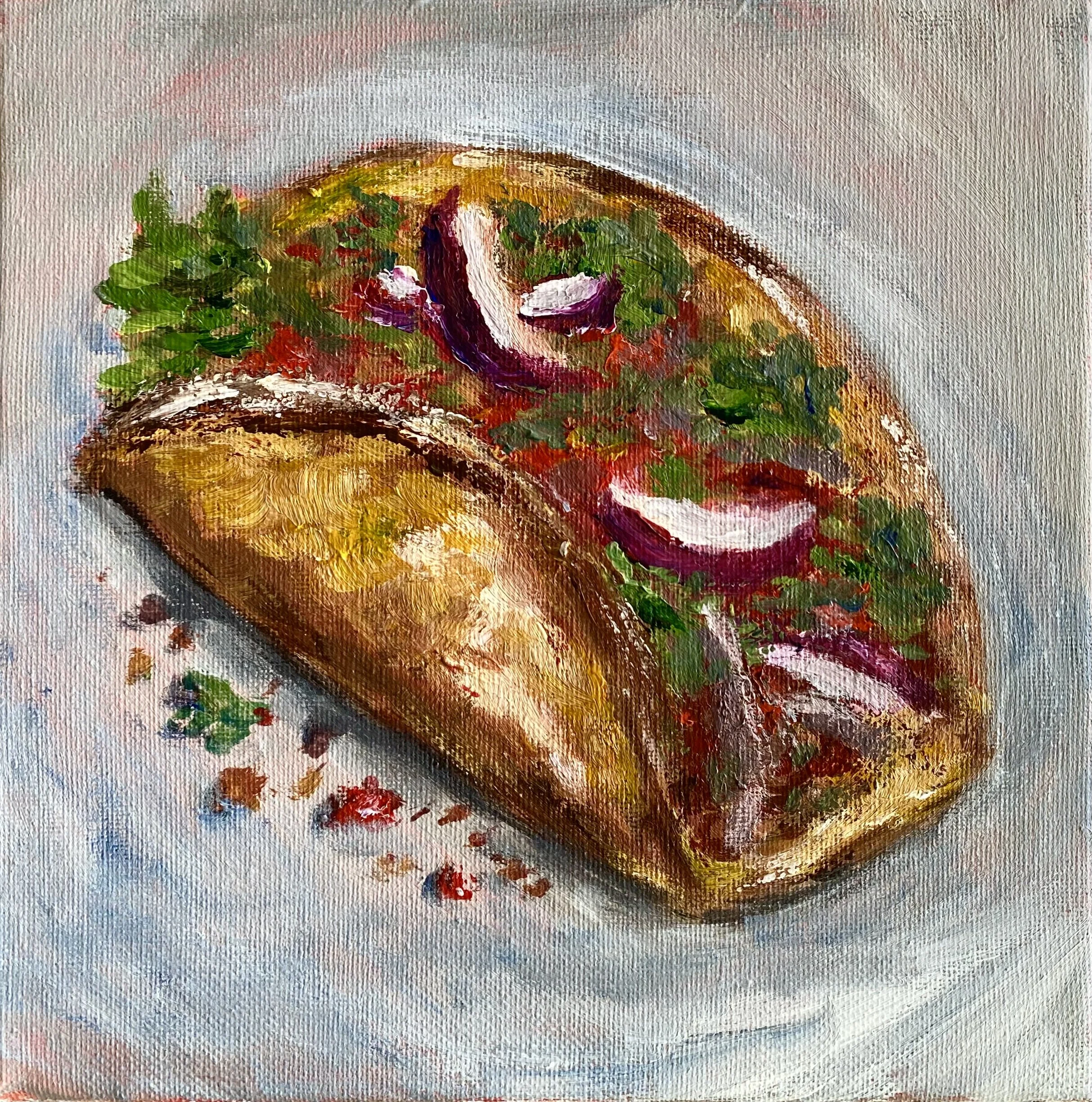 beef taco with lettuce, onions, tomatoes on grey background