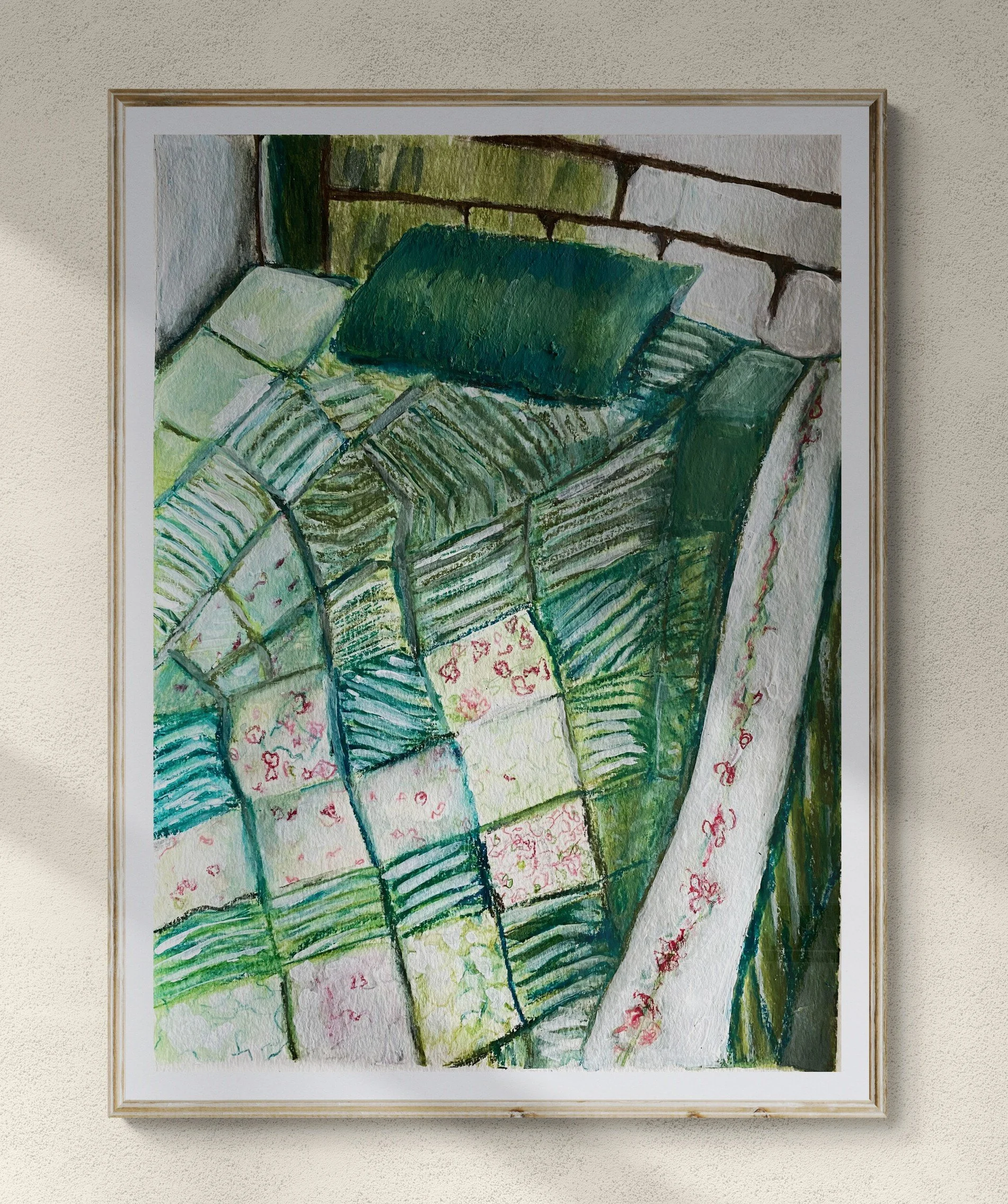 bed with green quilted cover and green pillow framed hung on wall.jpg