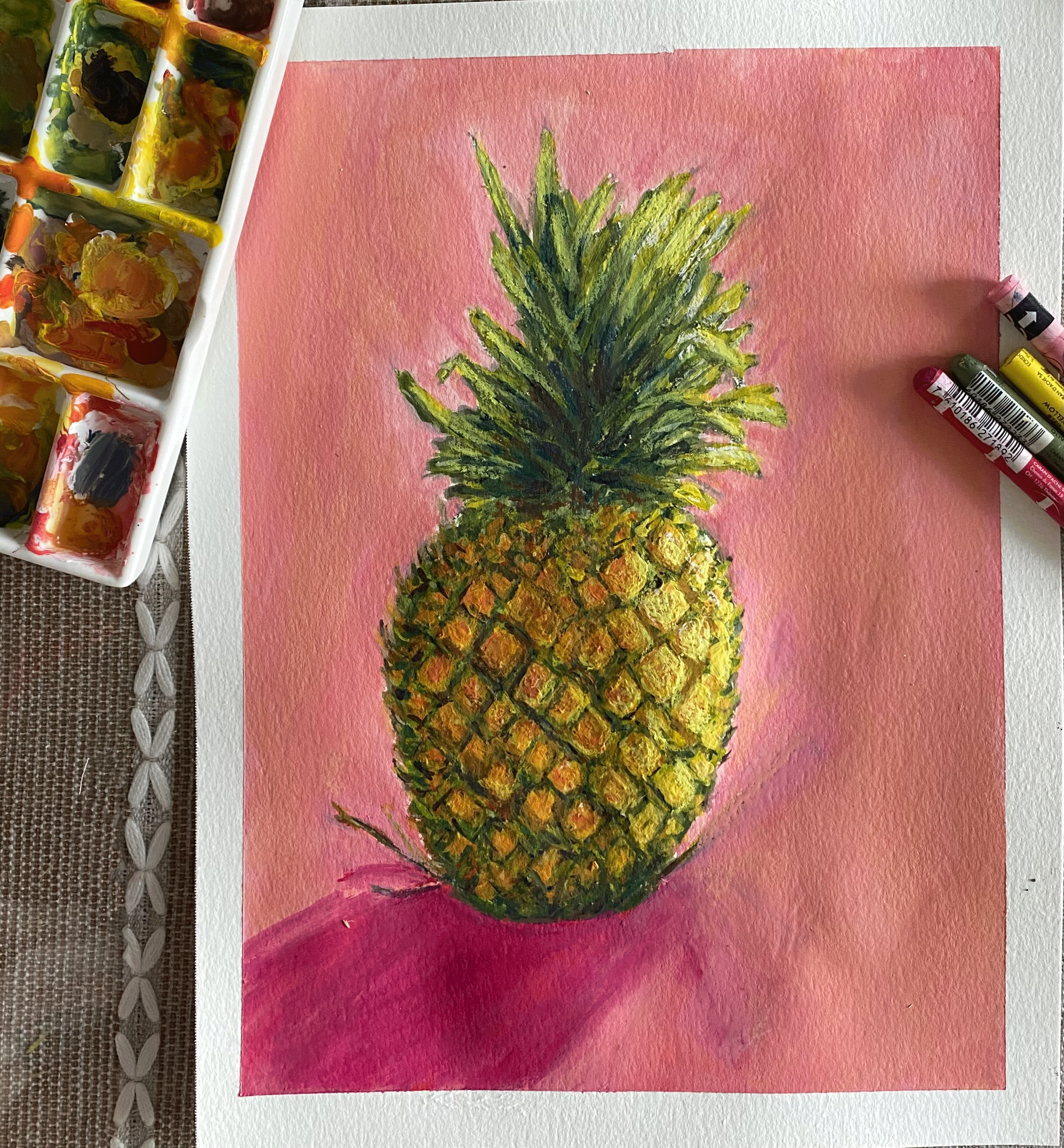 pineapple on pink background with art supplies.png