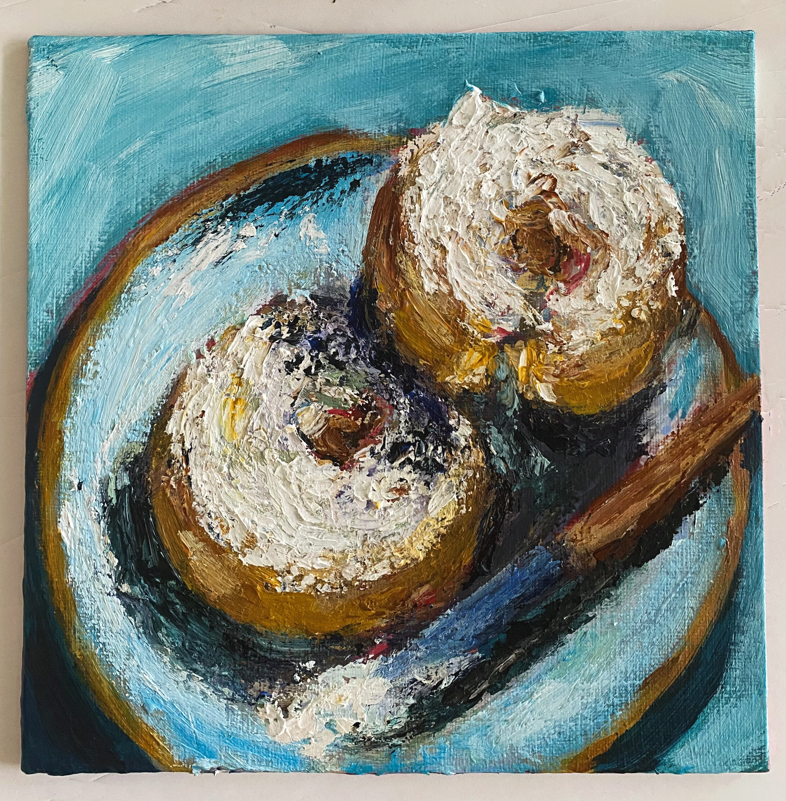 Bagels with crem cheese painting on teal background close up..png
