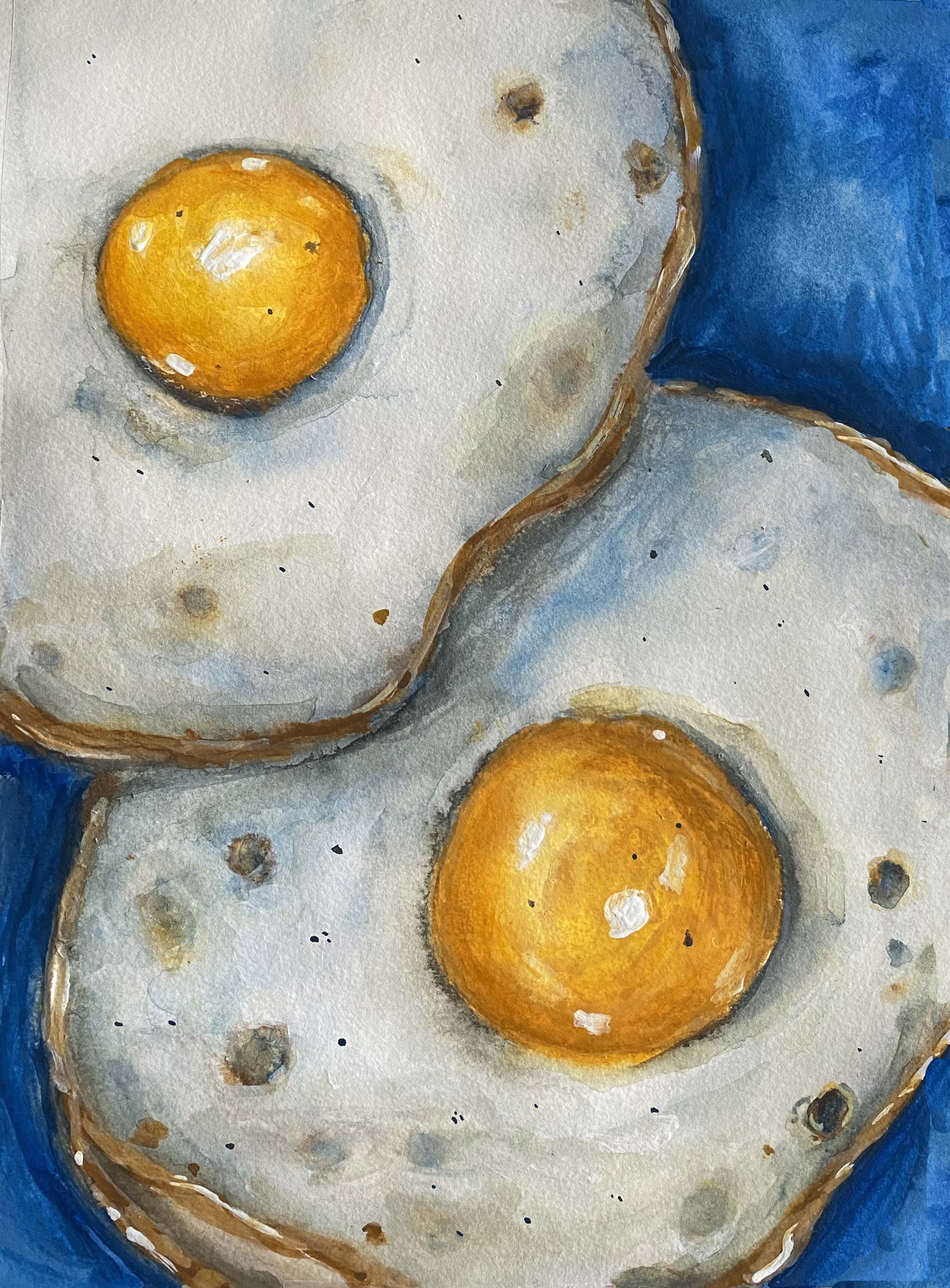 two sunny side up eggs on blue background close up.png