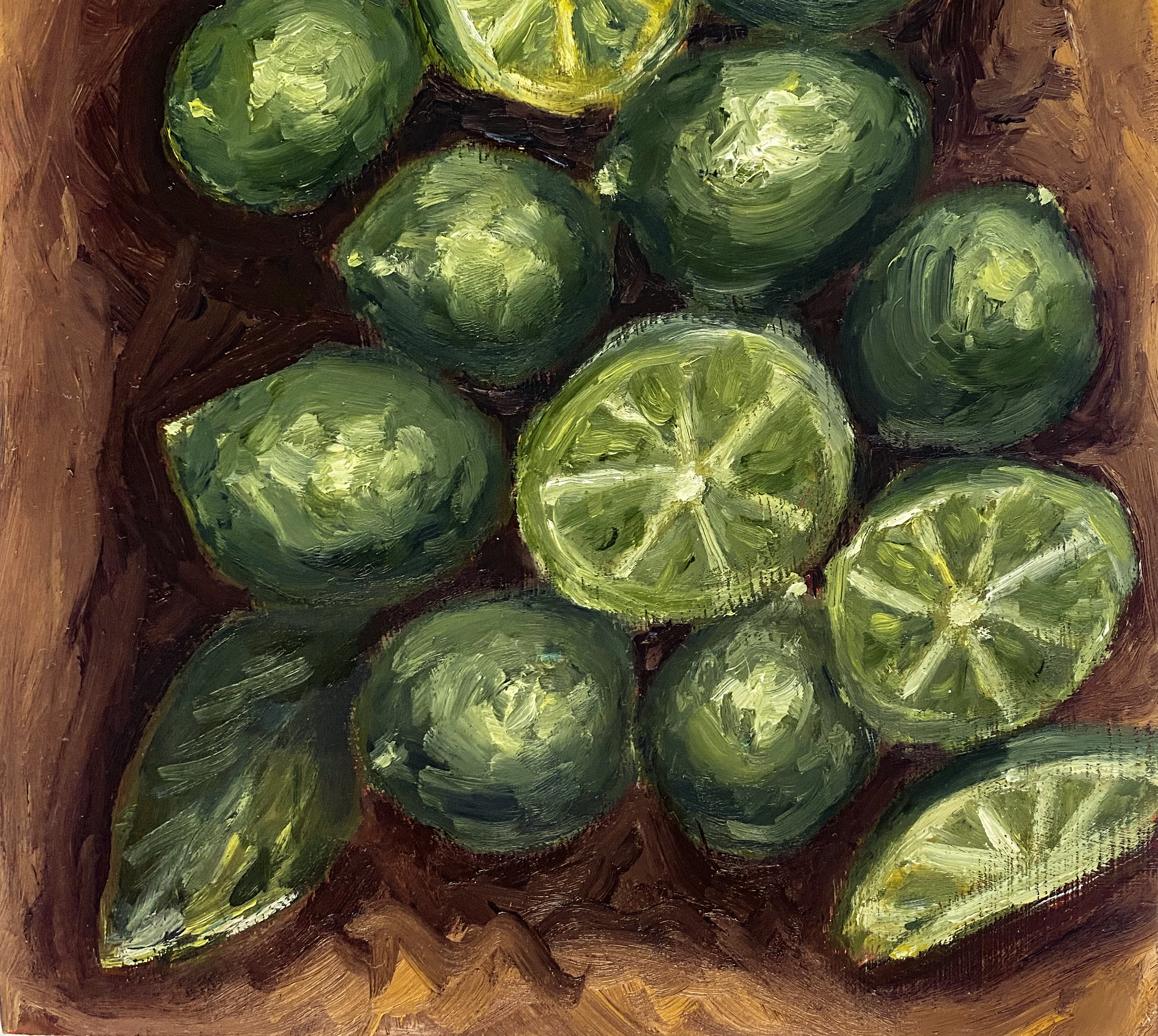 Close up of green limes on wood table.png