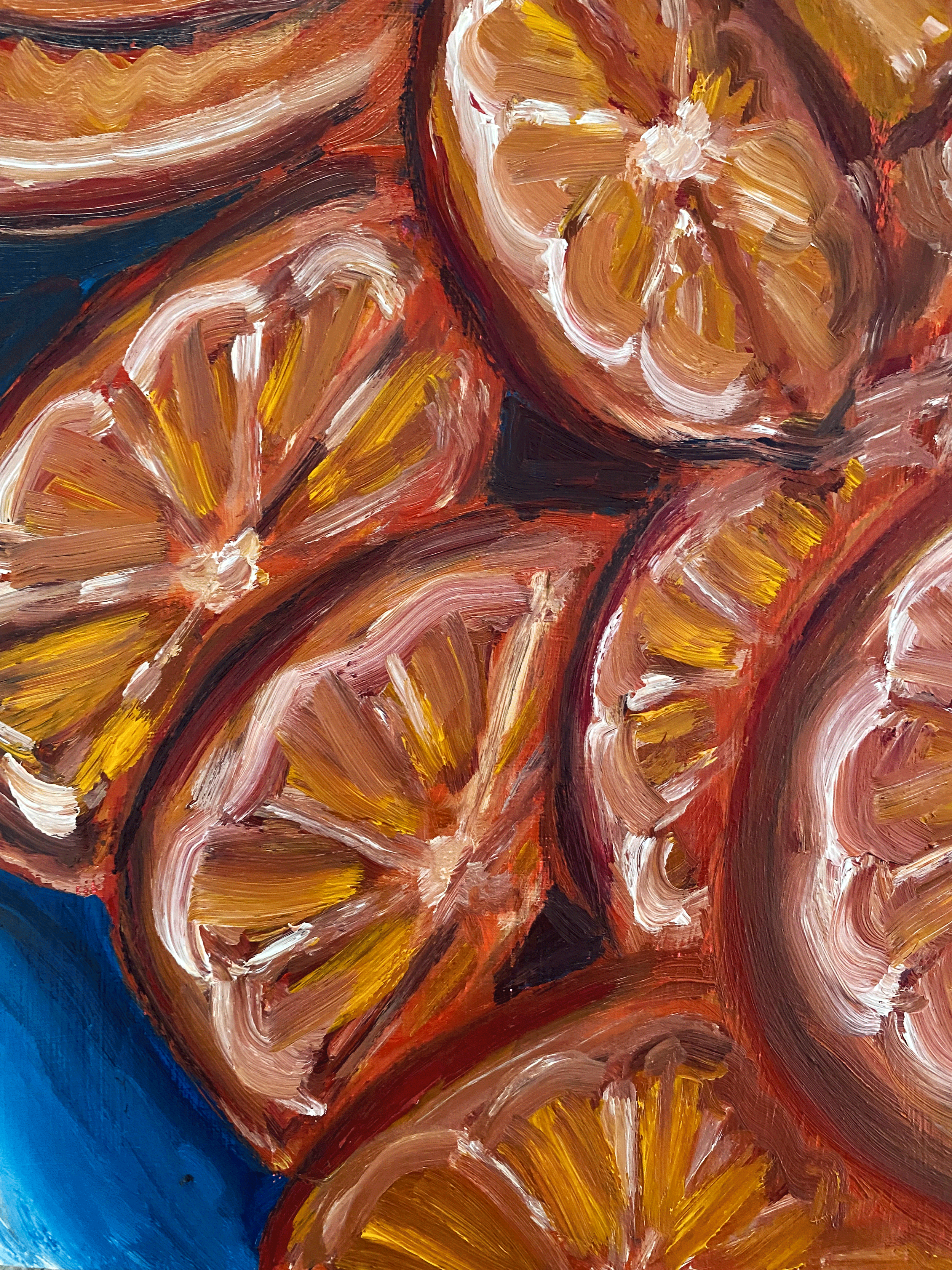 orange slices on blue background close up.png