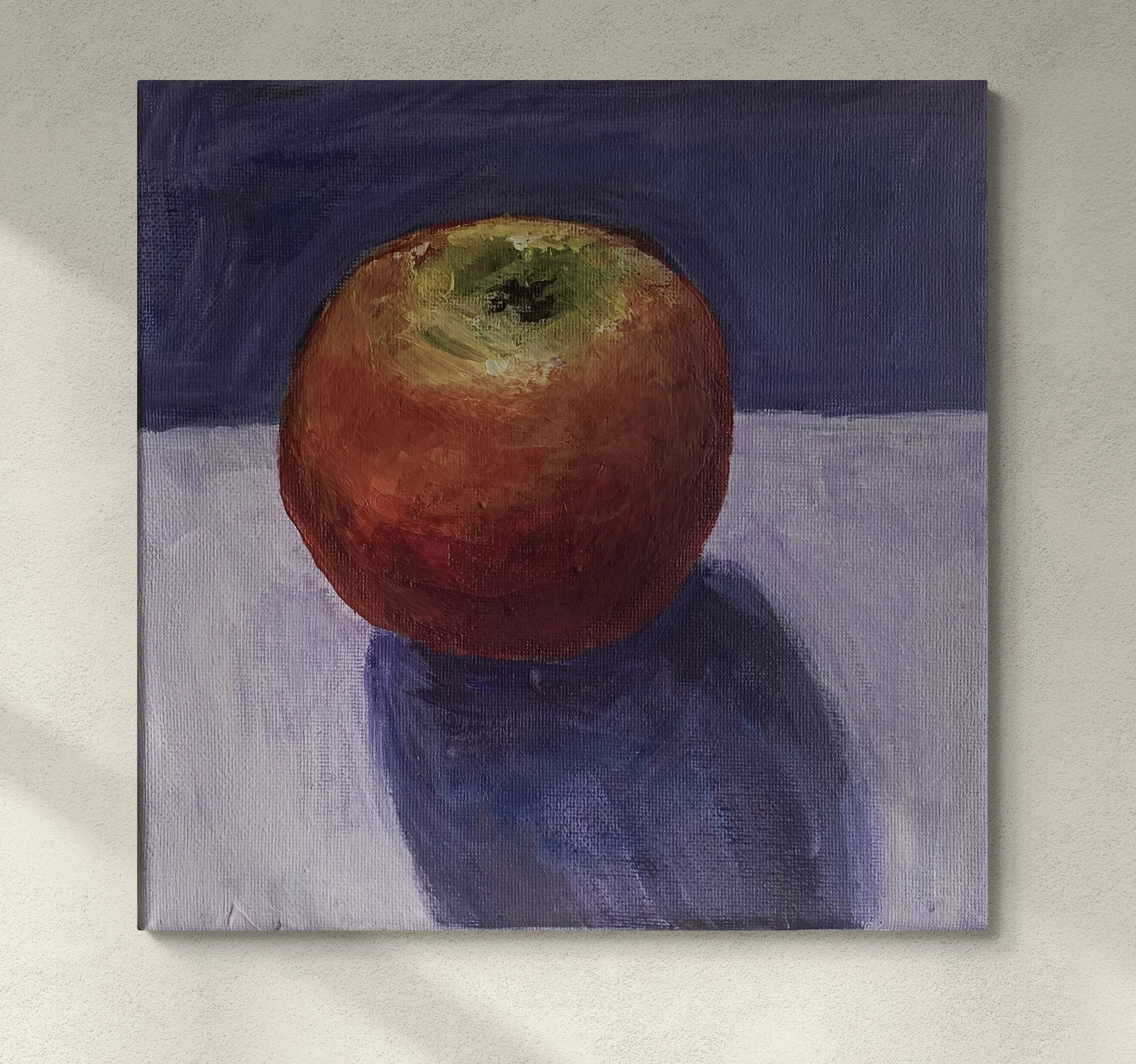 apple on purple background with shadow hung on wall