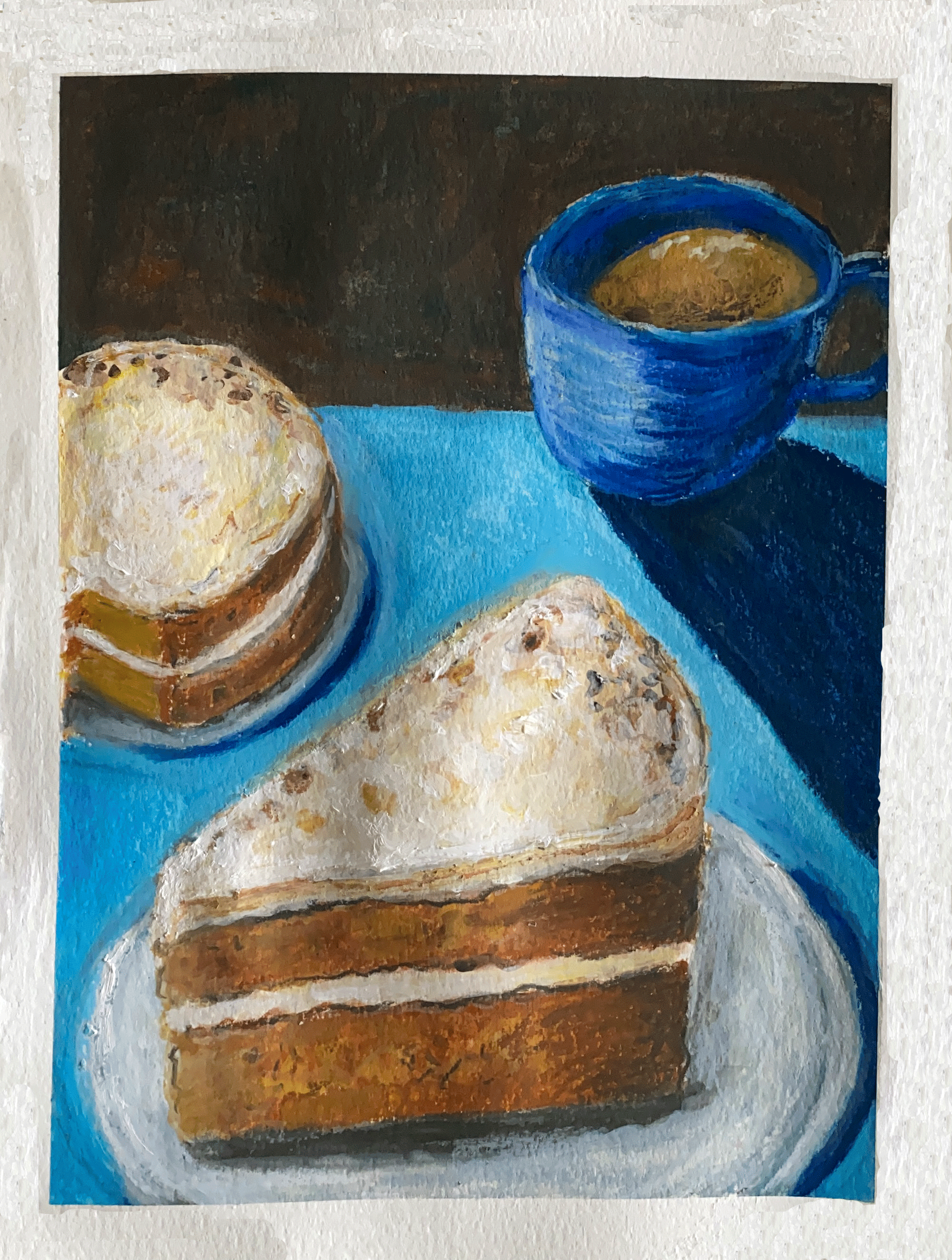 carrot cake with coffee on blue table and brown background.png