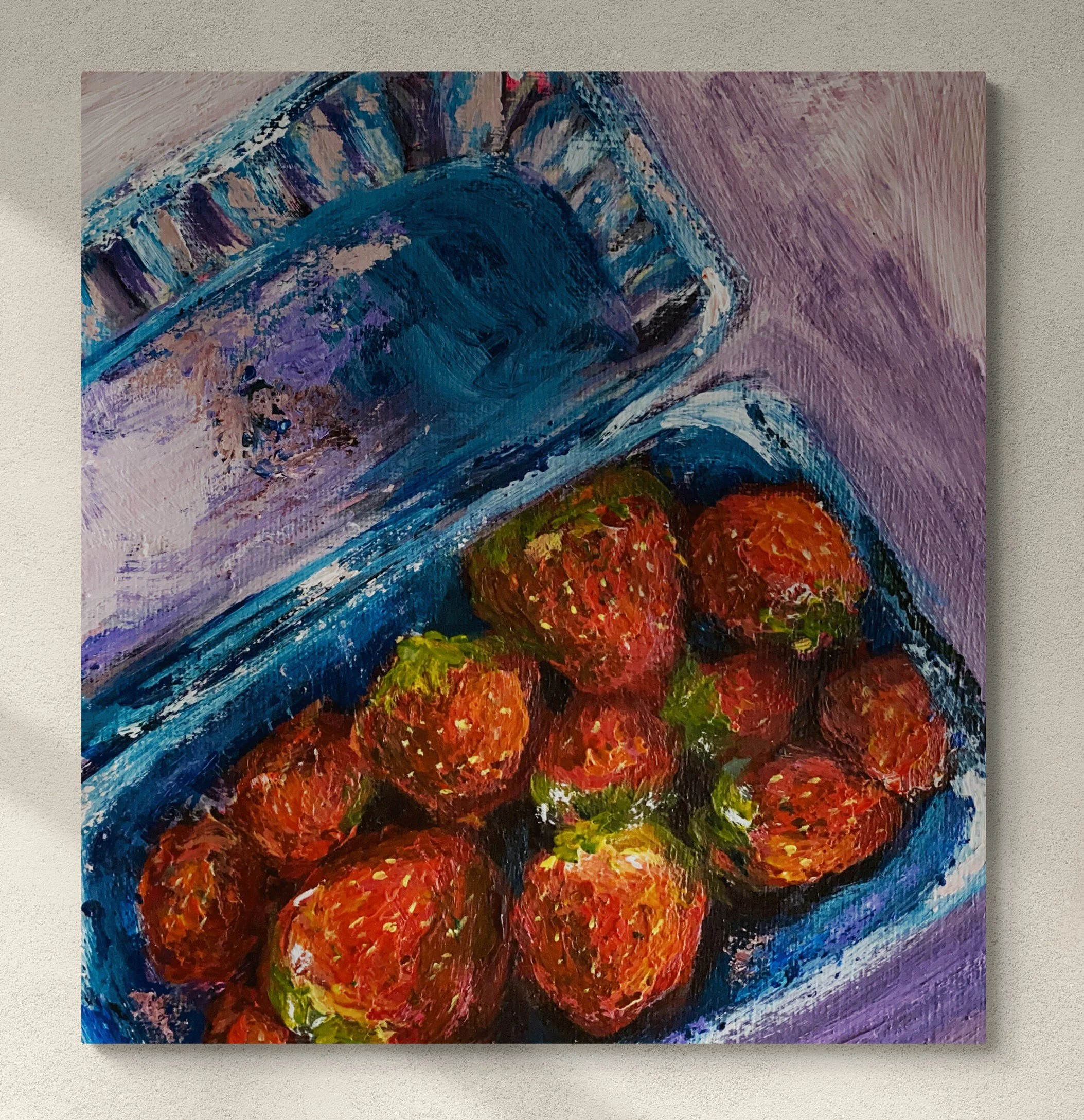 box of strawberries on lilac background