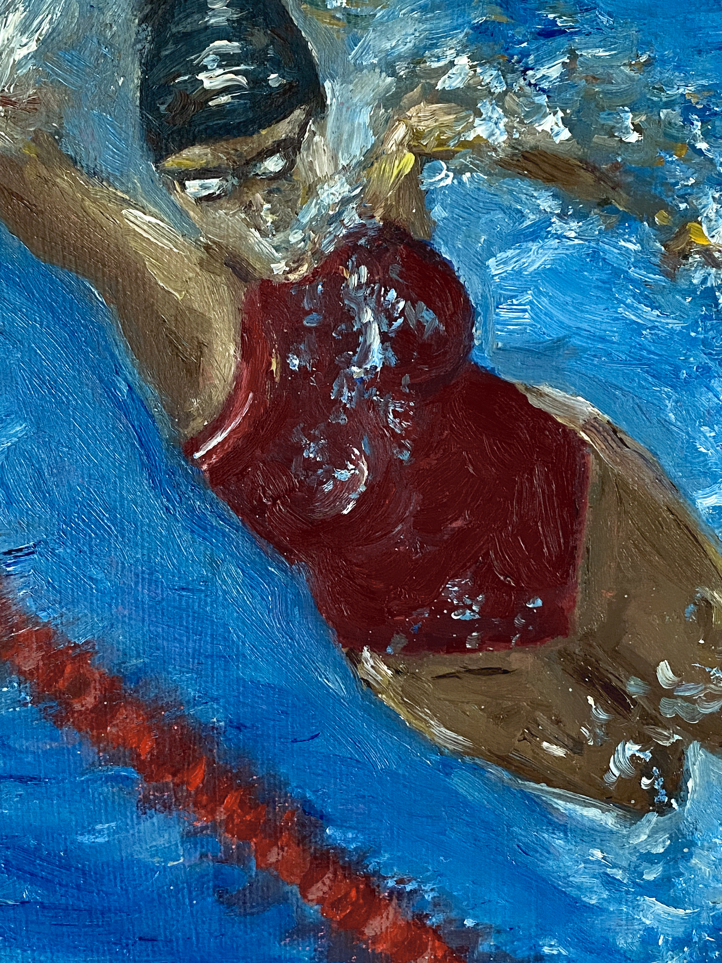 women in red swimsuit swimming view from below.png