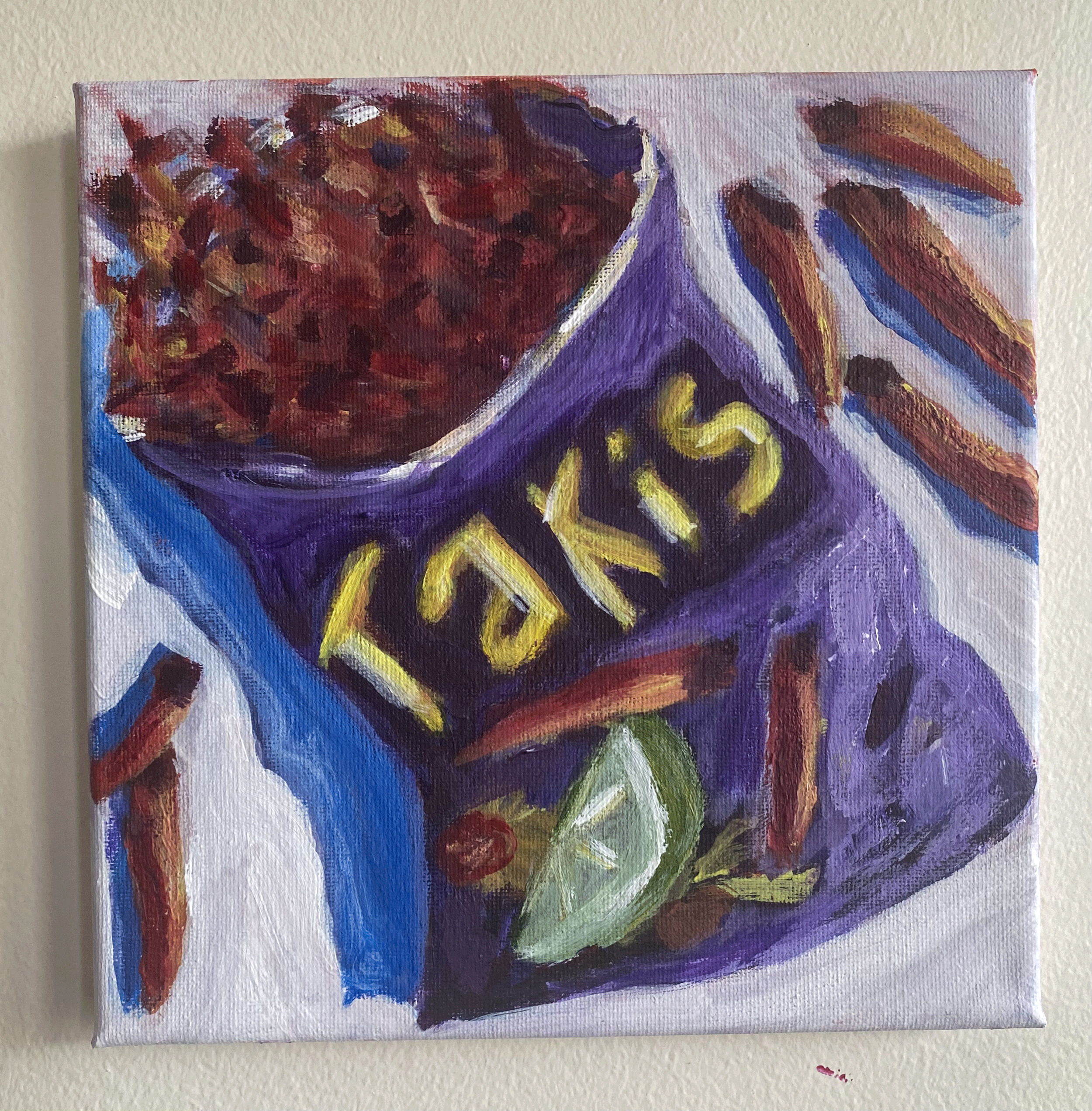 bag of taki chips purple on white background hung on wall