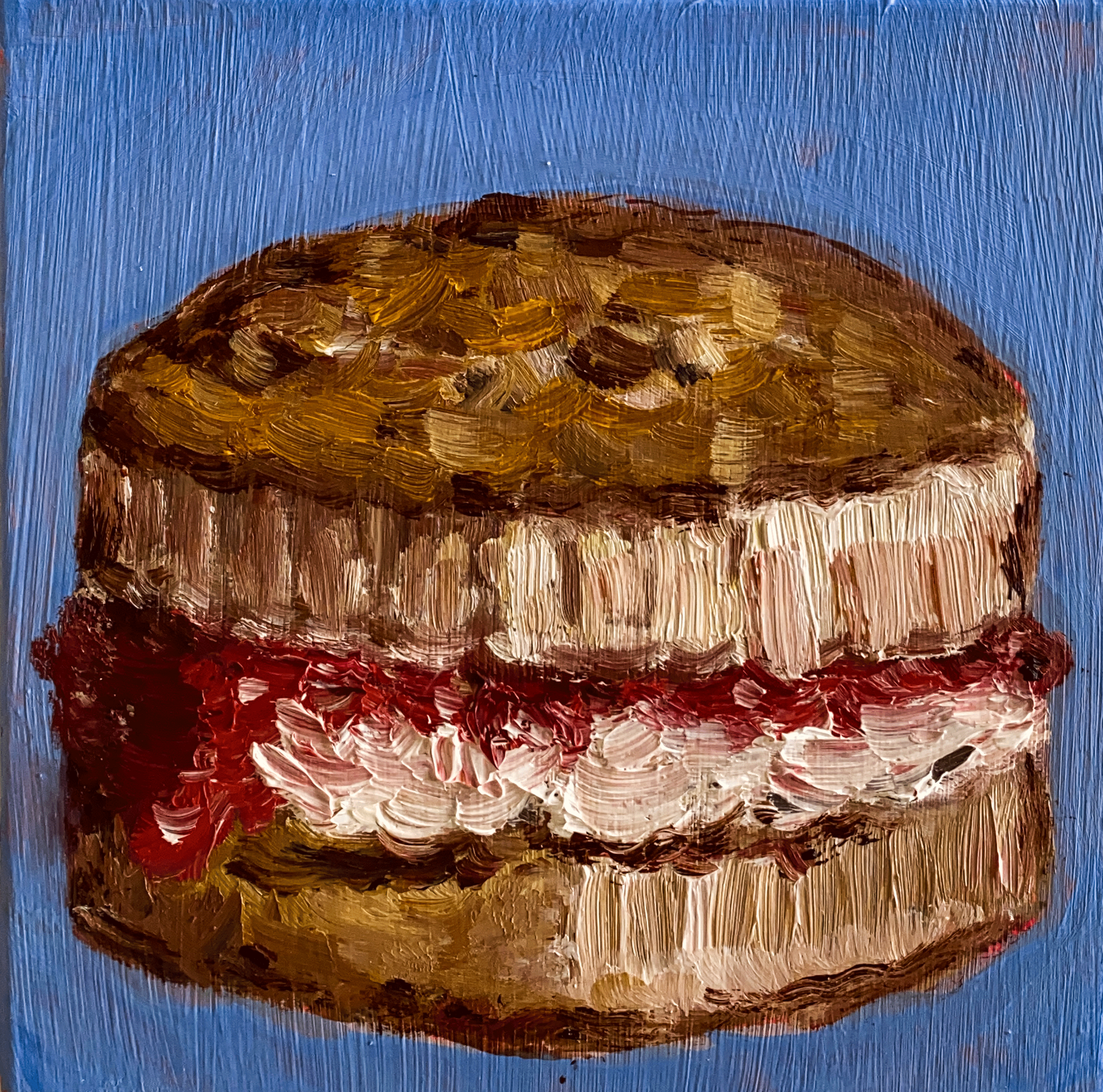 scone with cream and jam on blue background close up.png