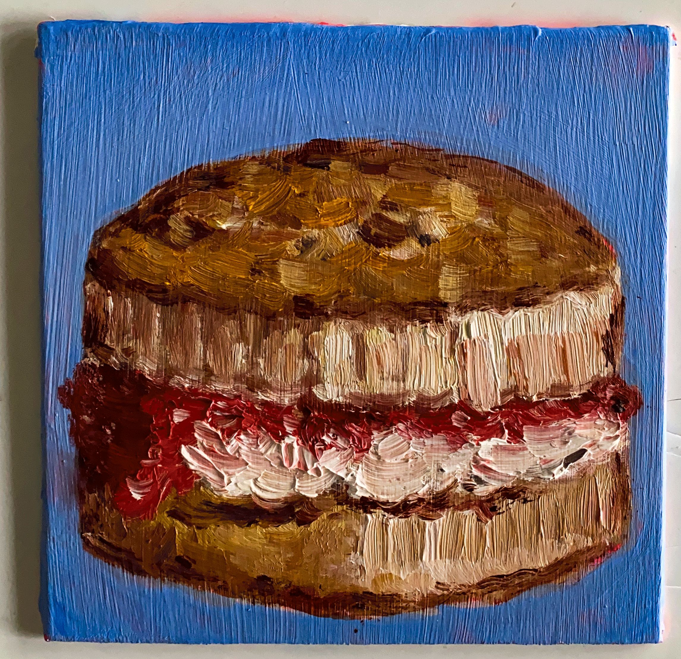 scone with cream and jam on blue background.png