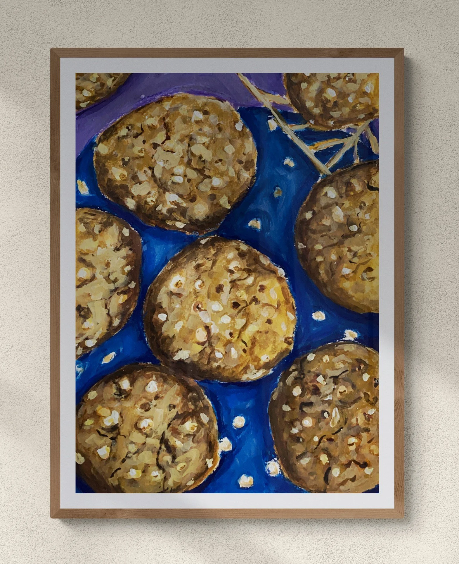 white chocolate cookies on blue plate framed hung on wall.pg