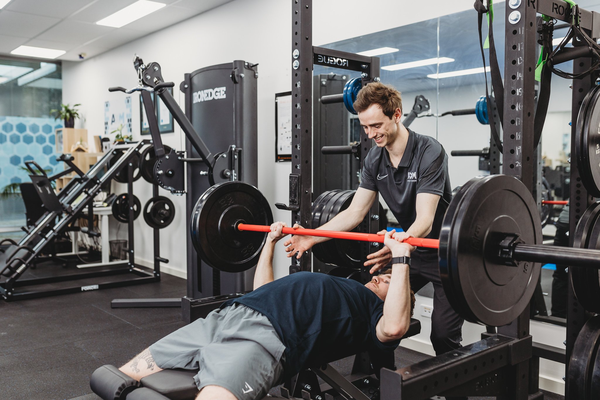 Canberra Branding Photographer - man helps with bench press