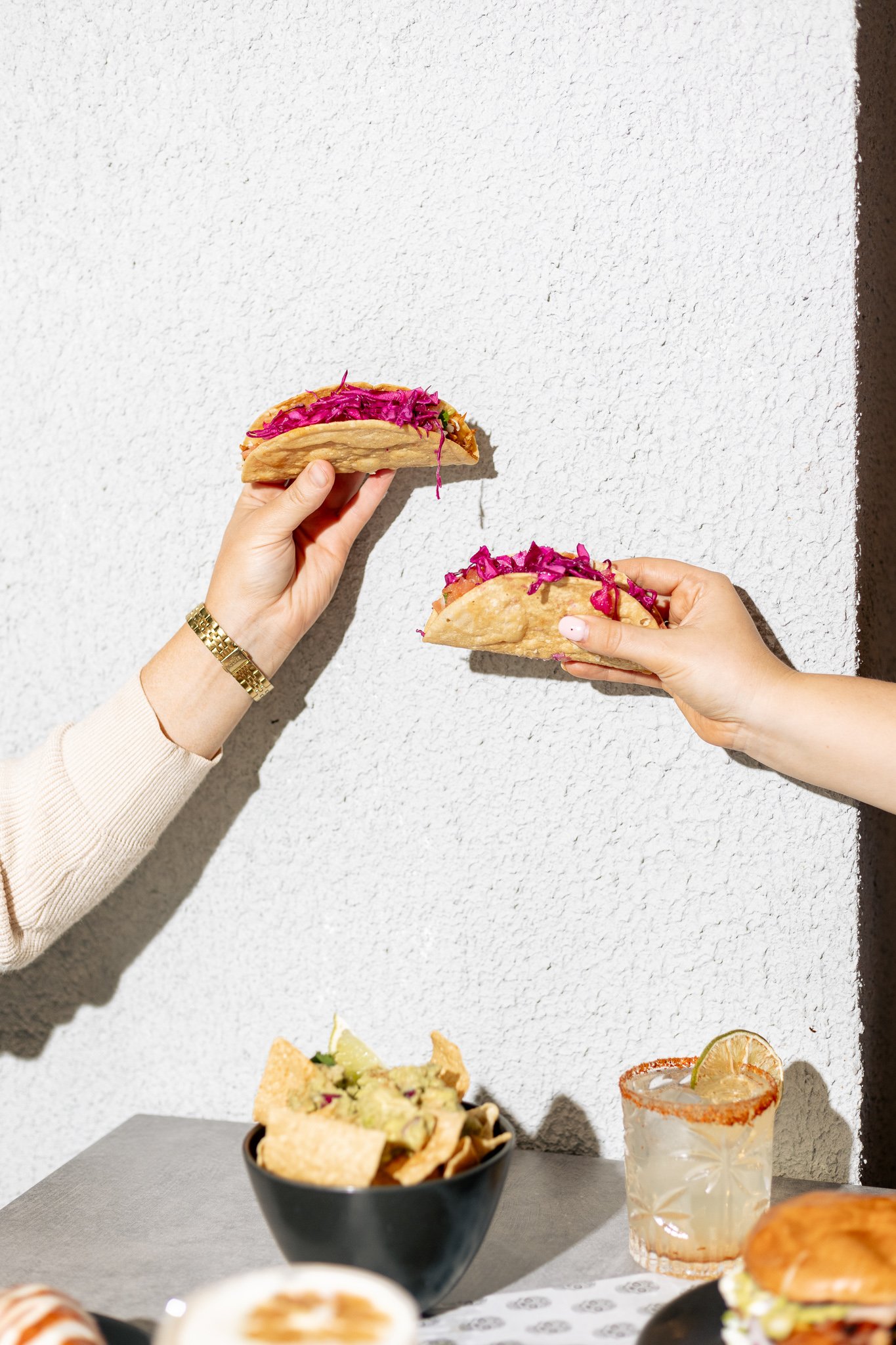Canberra food photography - hands hold tacos