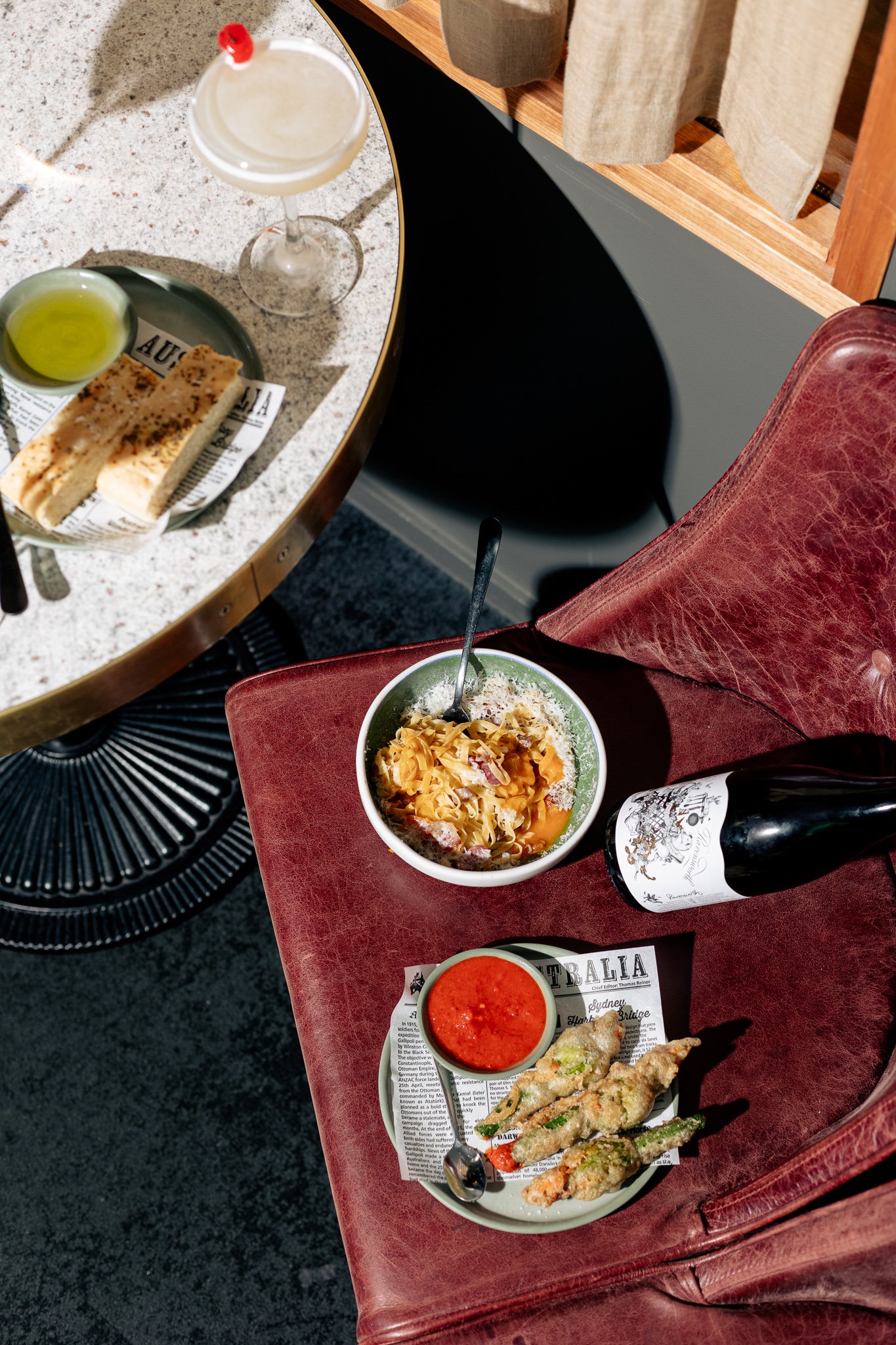 Canberra food photographer - pasta and wine on red chair