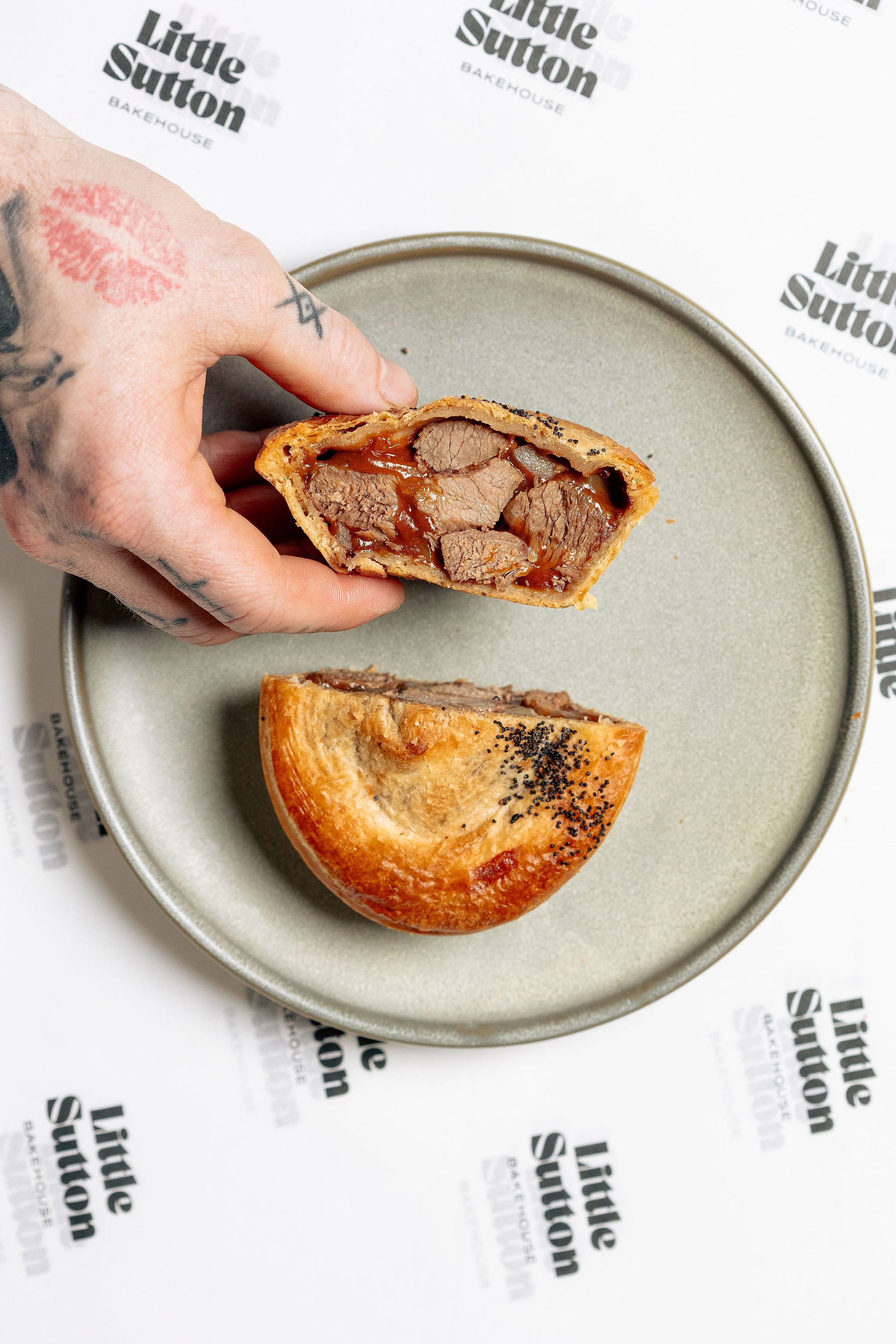 Canberra photographer - hand holds meat pie