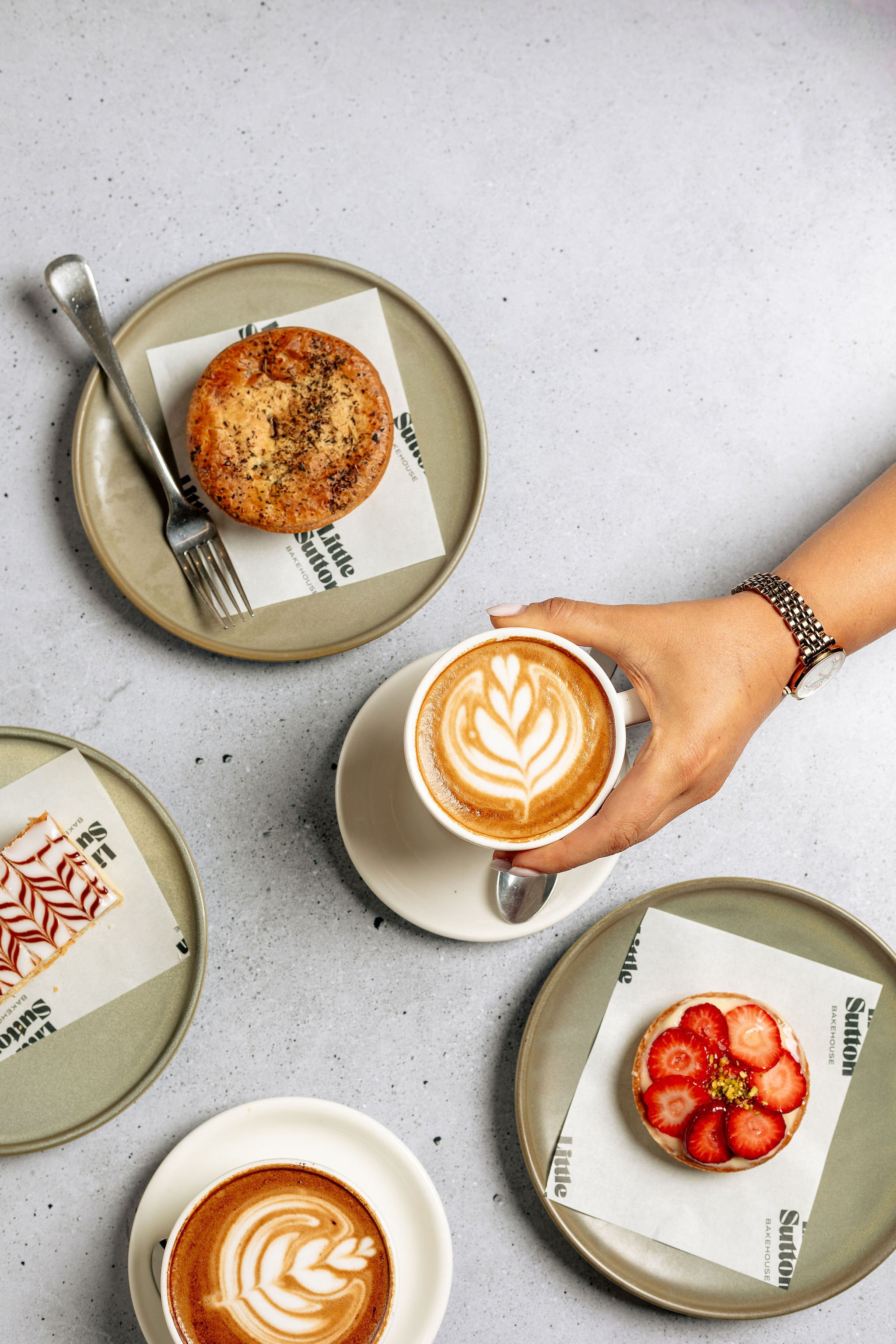 Canberra food photography - hand reaches for coffee