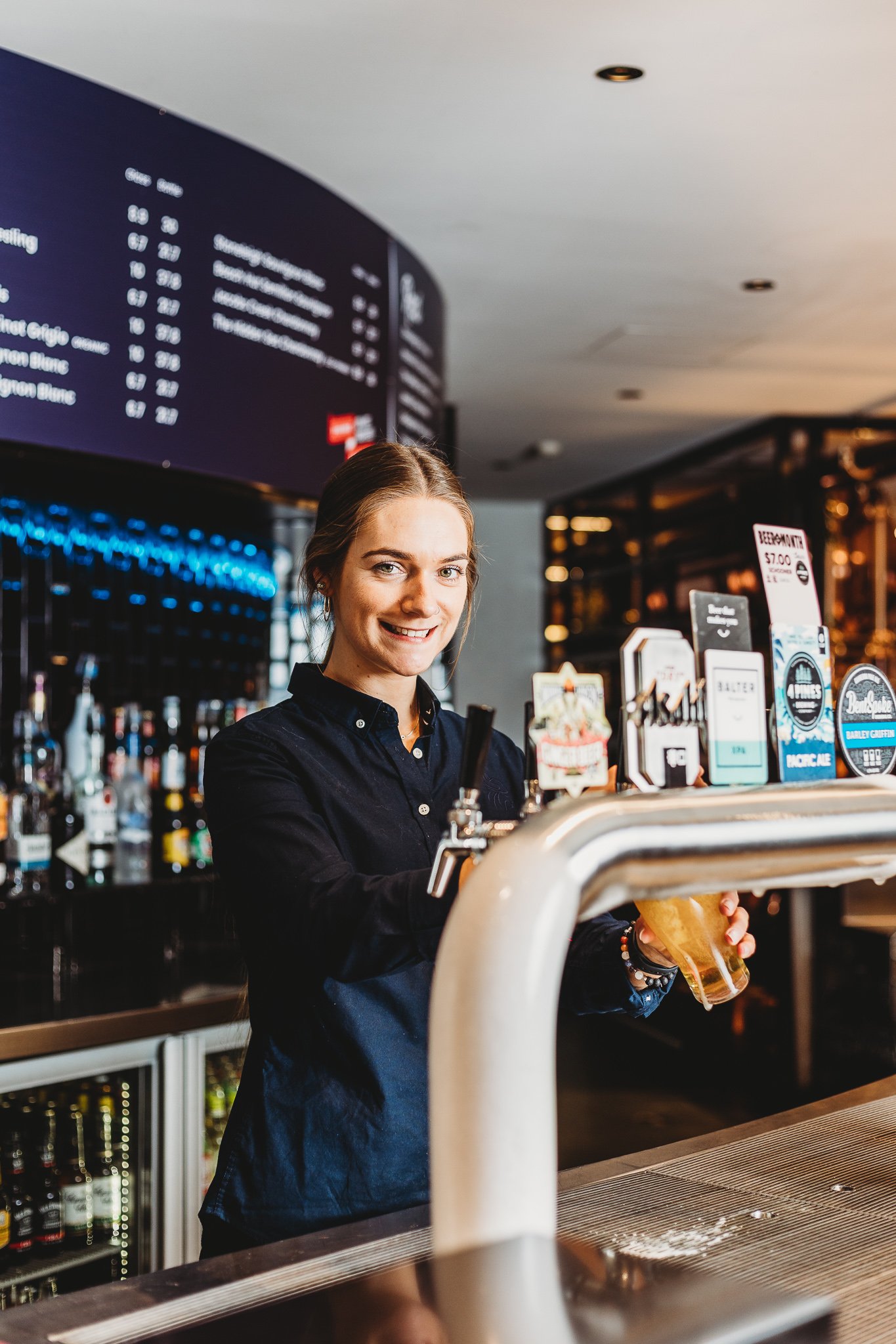 Canberra food photographer - smiling woman pours beer