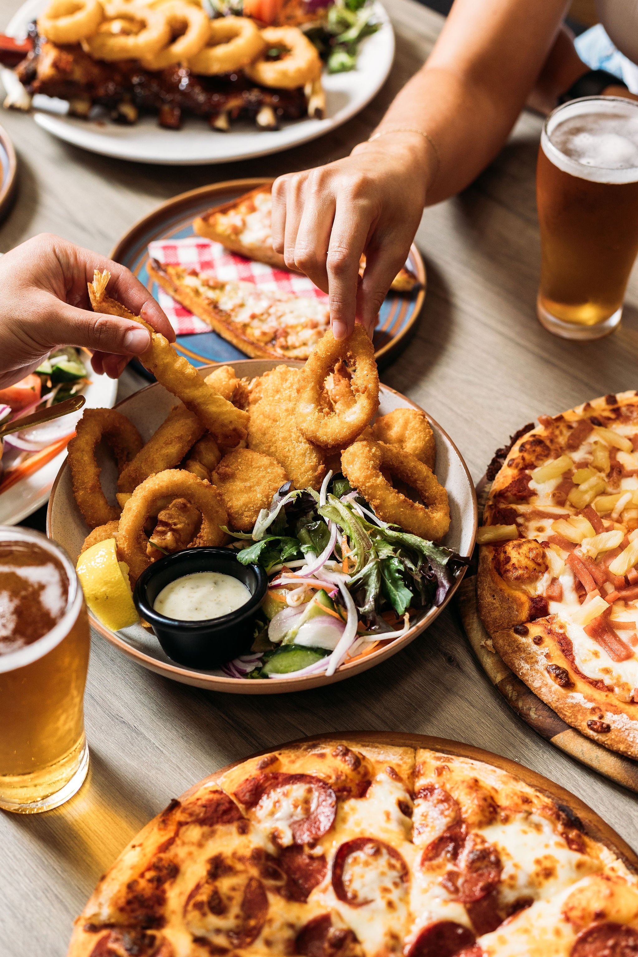 Canberra food photographer - hands reaching for food