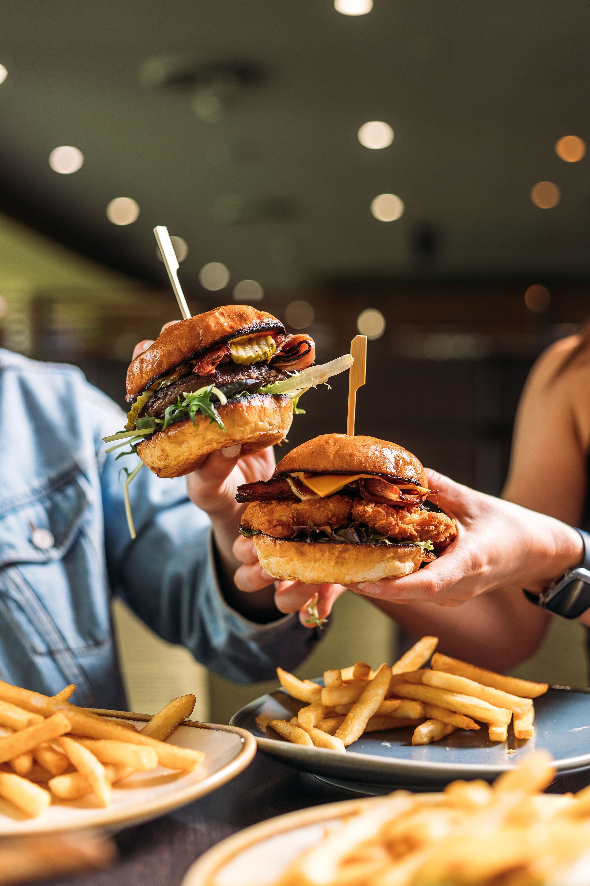 Canberra food photographer - hands hold burgers