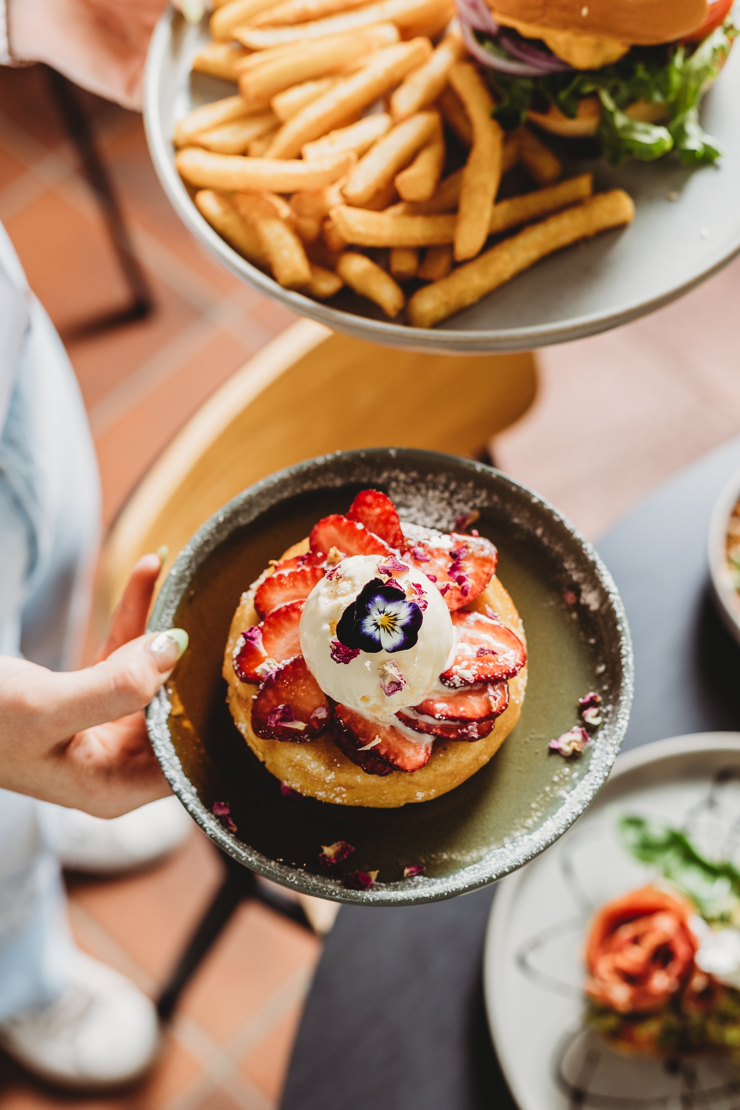 Canberra food photography - hands holding plates of food (Copy)