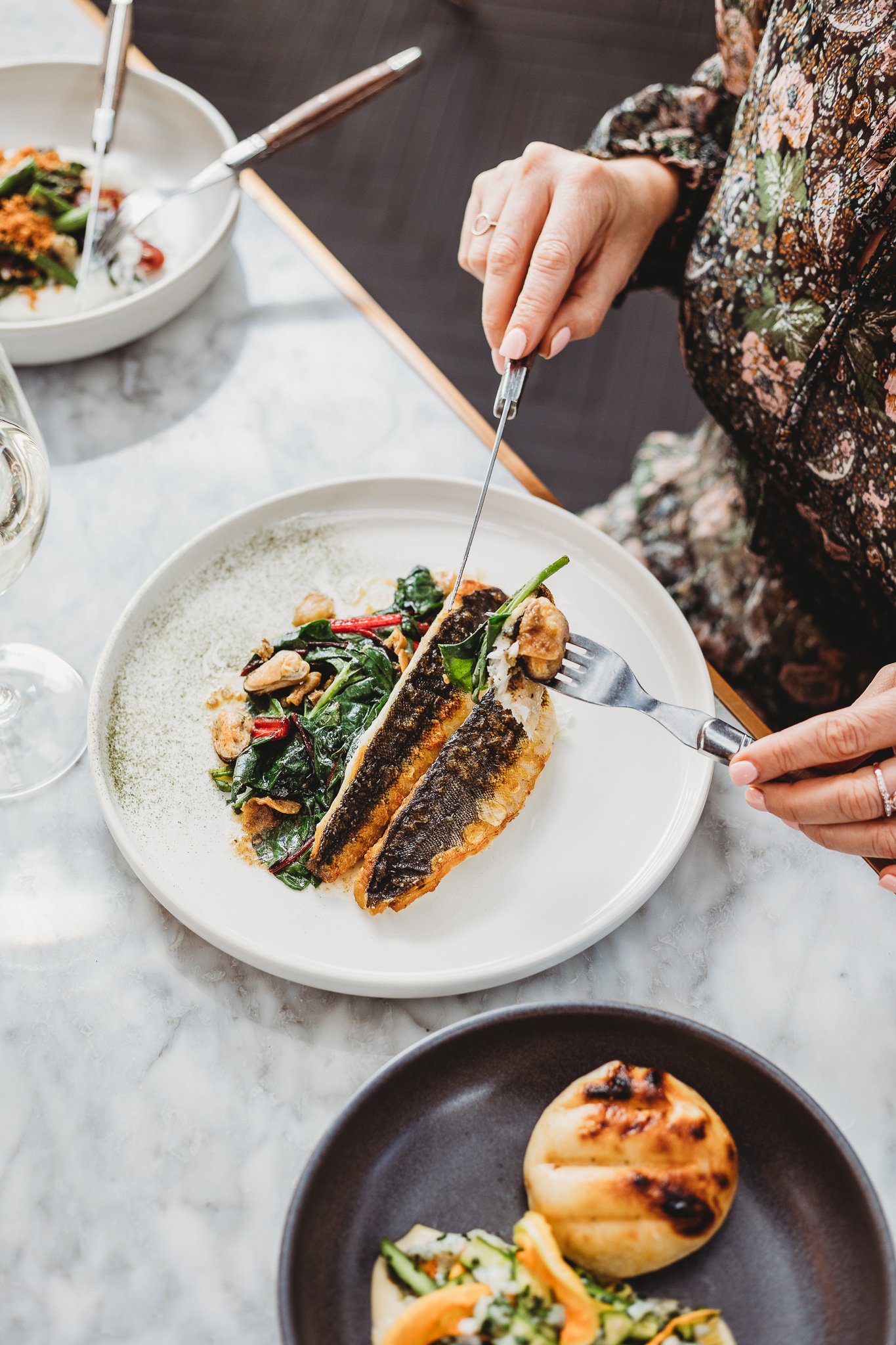 Canberra food photography - woman eats fish in restaurant (Copy)